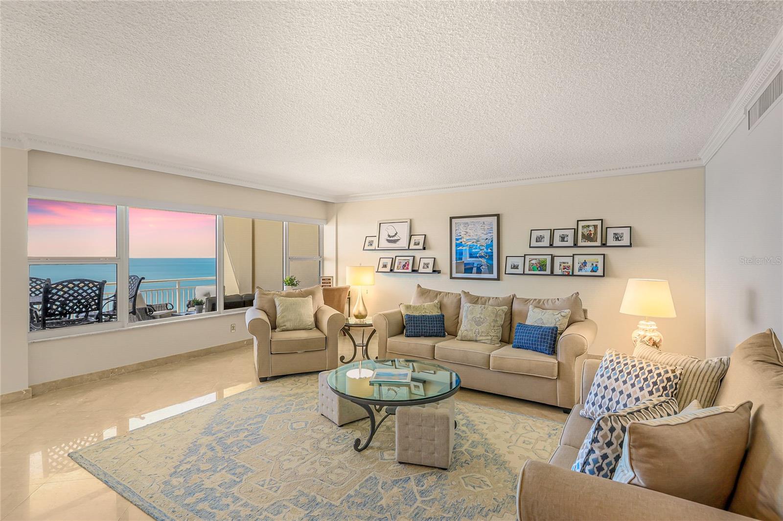 Stunning views await you in this 11th-floor Longboat Key Towers residence, located behind the gates of the world-class Longboat Key Club. A semi-private elevator opens into the tastefully appointed foyer of this 2-bedroom, 2-bath, 1,458-square-foot condominium showcasing unique floor-through Gulf-front and Bayfront views. Designed for comfort and convenience, the residence features impact windows and doors, in-unit laundry, a private storage closet, and deeded covered carport spaces.
The expansive 12-foot-wide Gulf-facing terrace is the perfect setting to enjoy breathtaking sunsets over the water, while the rear patio offers serene golf course and city skyline views. Savor an evening glass of wine as you take in the twinkling lights of downtown Sarasota and the Ringling Bridge. The open-concept living and dining areas are filled with natural light and designed for effortless entertaining. The spacious primary suite features a wall of windows overlooking the golf course and Sarasota Bay, along with a beautifully renovated bath offering a glass-enclosed rain shower, double vanity, walk-in closet with built-in safe, and custom makeup vanity.
The guest suite provides private access to the rear patio and equally captivating views. Residents of Longboat Key Towers enjoy a full suite of resort-style amenities, including direct beach access, 24-hour gated security, a heated Gulf-front pool and spa, fitness center, sauna, steam room, social and meeting rooms, and a welcoming lobby.
Guest suites provide comfort for visitors, and the association is exceptionally well managed, with Milestone and SIRS reports complete. Membership opportunities at the Longboat Key Club further enhance the lifestyle with access to world-class golf, tennis, dining, and marina facilities just moments away. Enjoy lock-and-leave beach-to-bay living near St. Armands Circle and downtown Sarasota.