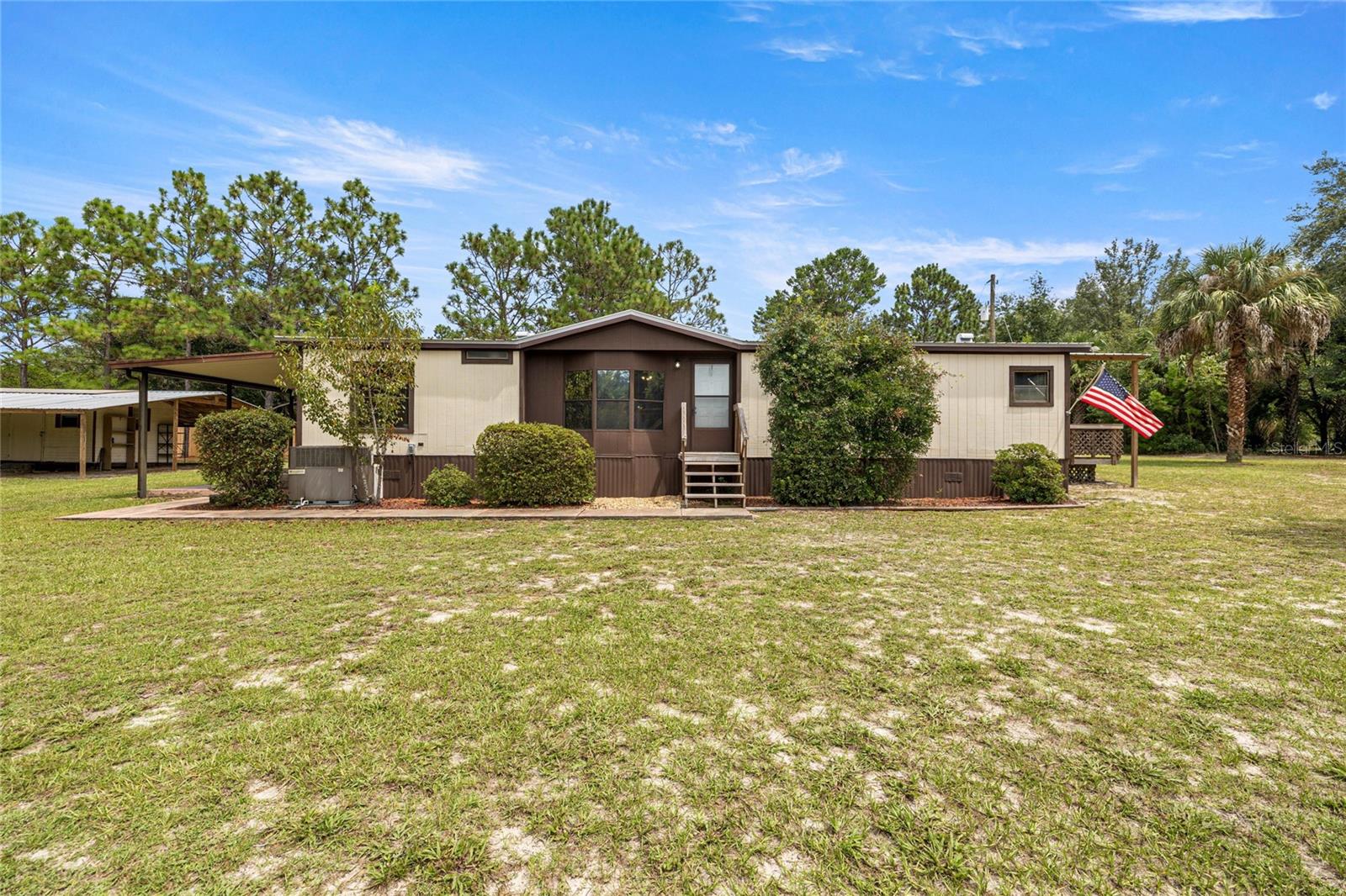 Escape to privacy and space on 3.19 acres with this 1988 double-wide manufactured home. Surrounded by nature, this property offers an open-concept layout with a dedicated dining room and plenty of updates, including new vinyl flooring, a new dishwasher, gas range, recently replaced two sinks and three faucets. The plumbing has been completely redone, giving peace of mind for years to come.
Additional improvements include a new toilet, exterior lights, and a new metal roof over the side porch—perfect for quiet evenings outdoors. The main roof was replaced in 2019.
The property is well set up for versatility with RV hookup (power, water, septic), outdoor lighting, and a 12x30 shop with lean-to ideal for projects, storage, or hobbies. With 3.19 acres, there’s ample room for animals, gardening, or even future building. Septic was pumped February 2025.
Conveniently located near the Suncoast, you’ll have quick access to fishing, biking, and outdoor recreation while still enjoying the privacy and space you’ve been looking for.
Property is being sold As-Is.