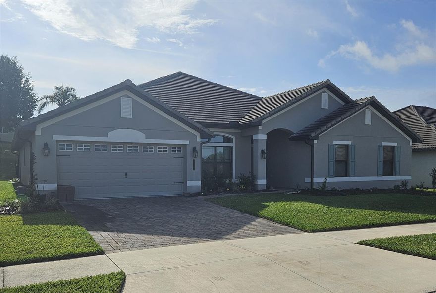Beautiful 4 bedroom, 3 full bath, Lake view home with multiple overlooking the gorgeous water skiing Lake Tennessee, built in 2021, situated in the gated community, Lake Juliana Estates!!  Over 3113 heated square feet of living space, this home features two car garage/workshop with new true grit high performance epoxied floor and paver driveway. Upgraded wood-look plank tile flooring flows throughout the entire home, very open floor plan. New concealed kinetico total home water soften with reverse osmosis filtration system.  Home has a durable tile roof with new bronze gutters and down spouts; open concept living space with a welcoming foyer leading to a spacious living room, featuring soaring vaulted ceilings, recessed LED lighting and multiple ceiling fans. The formal dining room, illuminated by an upgraded chandelier, complements a cozy dinette off the kitchen. The chef’s kitchen boasts a breakfast bar, granite countertops, a chef’s island, stainless steel appliances, and ample soft-closing cabinets and drawers, plus a walk-in pantry leading to an extended laundry room with a built-in laundry sink, newly installed custom cabinets, and newer washer/dryer. The east-facing extended screened lanai (upgraded) features a pavered lanai, dual ceiling fans, a 55” flat screen TV, space for patio furniture and entertaining. The large owner’s suite accommodates king-sized furniture, with a sitting area, recessed ceiling with crown molding and ceiling fan.  The master bathroom features dual walk-in closets, dual granite vanities, a garden tub, a tiled walk-in shower, glass doors, linen closet and a new custom plywood cabinet over the toilet. The three additional bedrooms are spacious, two with walk-in closets, and are served by two full bathrooms with granite vanities, upgraded lighting, and tub/shower combos. Additional highlights include an in-wall pest system, double-paned windows, an EV charging station in the garage, flooring above garage for storage and an irrigation system. Newly installed aluminum fencing with puppy rails,  two gates and new landscaping.  Located less than a mile from Publix, this home offers unmatched convenience. The gated Lake Juliana Estates community offers residents exclusive amenities, including a breathtaking community pool with stunning lake views, a rentable clubhouse, a fitness center, a private dock and boat ramp on Lake Juliana, tennis, basketball, pickleball courts, and playground.   Don’t miss the breathtaking sunsets from your new home, please call today!! Property is owned by a licensed realtor.