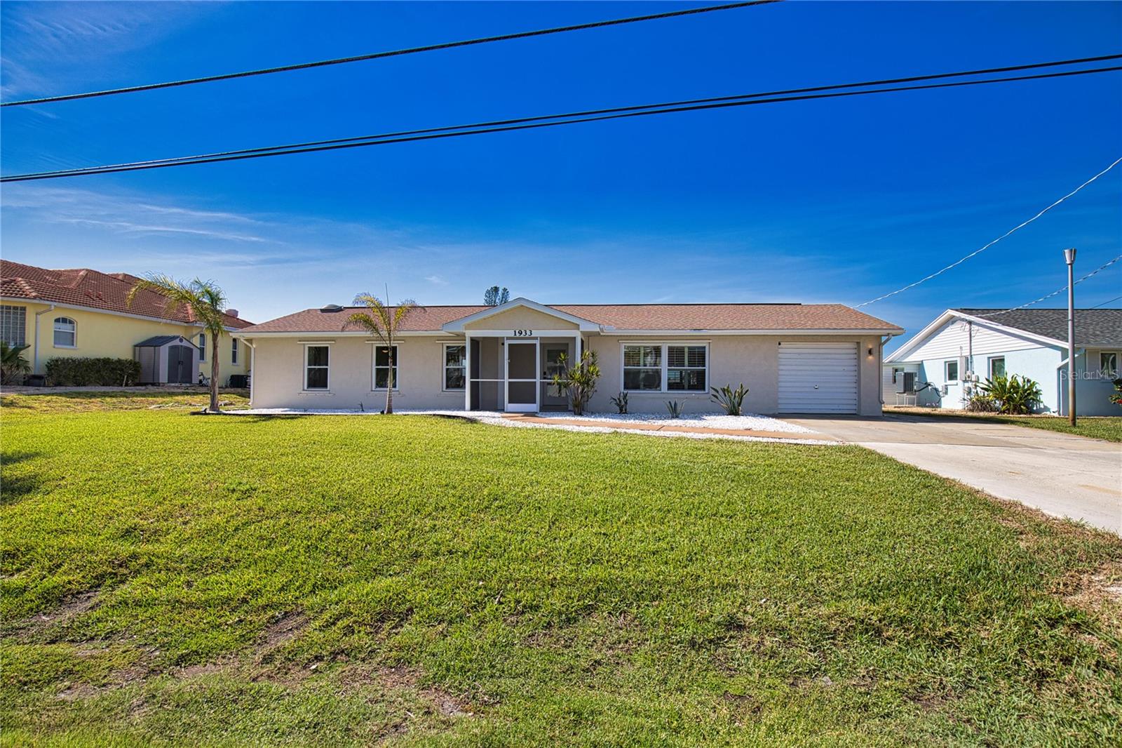 This lovely home has quick access to the canal and is just minutes from the sea. Kayak, fish, and paddleboard straight from your private dock. Inside, you’ll find a fresh, modern design; outside, enjoy stunning views.
A separate laundry room keeps washer and dryer noise out of the living areas. The heated pool is for cooler days, while the screened patio provides a relaxing retreat when the weather heats up.
The property includes both a boat lift and a jet ski lift, with ample space to maneuver in the canal. The well-landscaped lawn features lush plants and a sprinkler system to keep everything green. Concrete walls and central AC ensure you stay cool all summer long.
Parking includes a one-car garage plus space for four additional vehicles in the driveway.