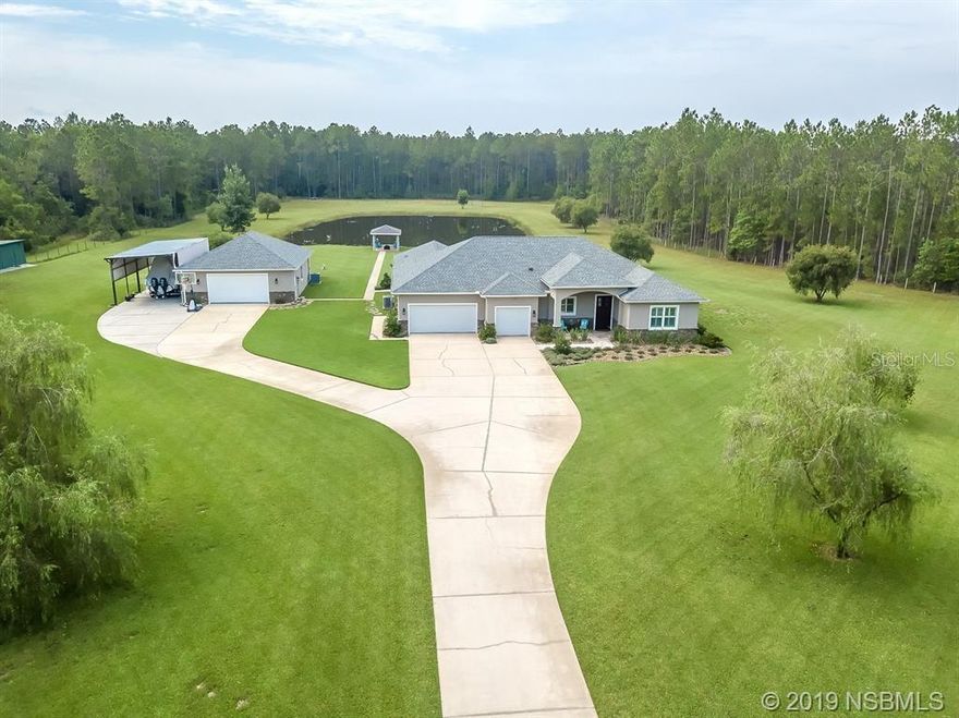 Located off a long, concrete driveway, your estate is not visible from the street, has an automatic gate for access and is nestled in a Florida pine forest creating a natural noise buffer. Of the 22.7 acres, approximately 5 acres is landscaped, fenced and irrigated, including a stocked pond.