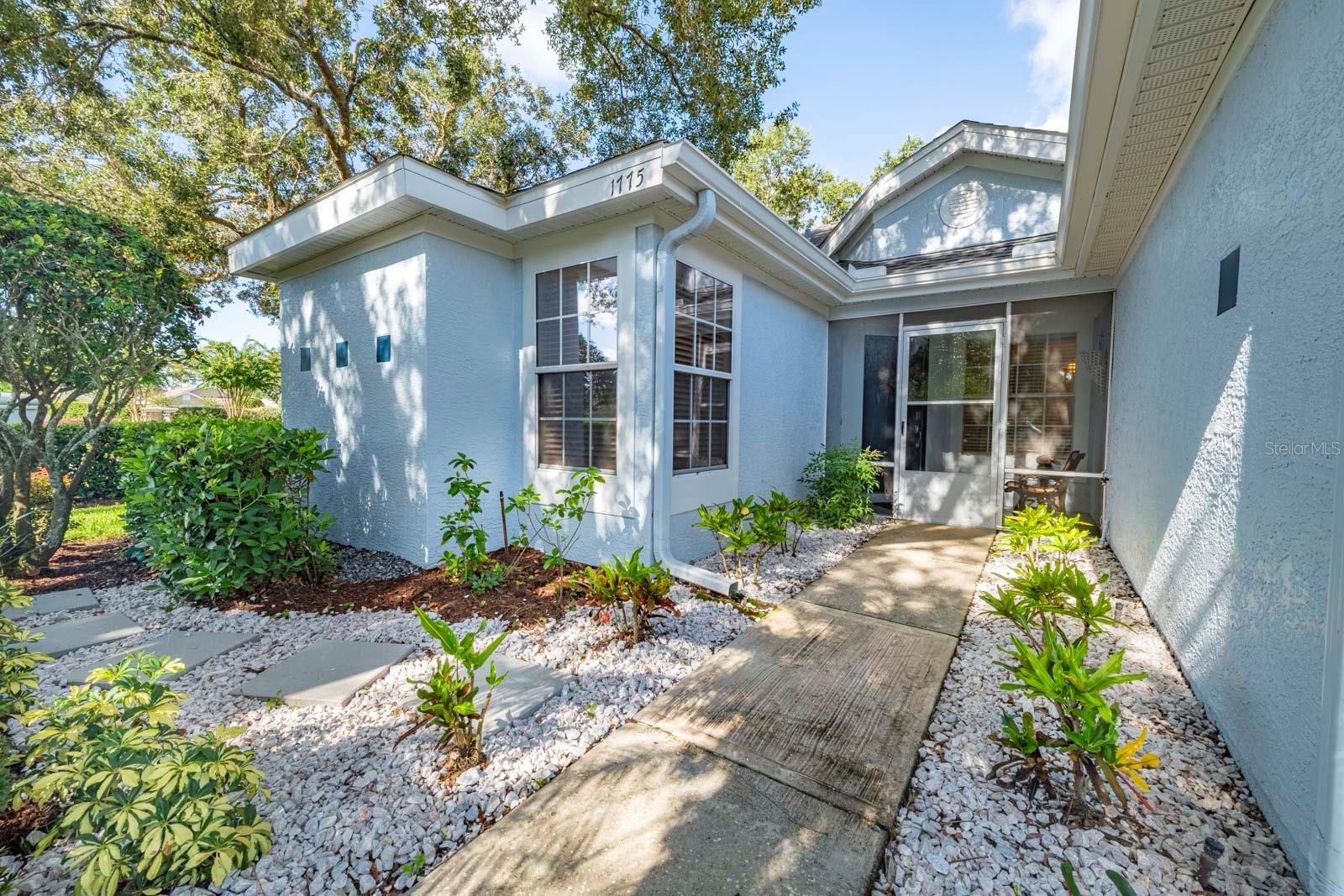 Turnkey Cottage in the Country Club of Mount Dora --- Looking for a Florida retreat that’s fully furnished and move-in ready? This charming 2-bedroom, 2-bath Villa is the perfect turnkey option—ideal as a seasonal retreat, second home, full-time residence, or short-term rental property investment. Located at 1775 Country Club Blvd, right across from the pool, tennis courts, and clubhouse, it offers the best of easy living, comfort, and community. Step through the screened breezeway into a light-filled great room with vaulted ceilings and a peaceful view through the sunroom to a private backyard. The split-bedroom design ensures privacy: this spacious primary suite features an airy bedroom and the primary bathroom has dual sinks, a walk-in shower, and ample closet space. The guest bedroom and bath are located on the opposite side of the home making it ideal for overnight company. Renovated in 2022, the cottage boasts new engineered hardwood and vinyl flooring, a cozy dining nook, and an updated kitchen with brand-new stainless-steel appliances, a pantry, and fully stocked cupboards ready for immediate use. The sunroom offers a welcoming spot for conversation or overflow guests with its sleeper sofa, while sliding glass doors open to a shady sitting area framed by hedges and mature trees. Additional highlights include a single-car garage, high-end washer/dryer, and excellent storage—including a versatile closet that is large enough to serve as a compact home office. Part of the Country Club of Mount Dora’s uniform yard maintenance program, this home is designed for carefree living. Just across the street, enjoy optional memberships for golf, tennis, pickleball, and swimming—or take advantage of the public clubhouse with dining and social events. Beyond the Club, historic downtown Mount Dora awaits with its festivals, shops, and lakeside charm. Nature lovers will appreciate the nearby springs, Wekiva Trail, and fishing spots. And, ideally, Orlando’s airport and attractions are only 45 minutes away! Whether you’re ready to downsize, retire in style, or simply enjoy a low-maintenance second home in the Florida sunshine, this cottage is a true find. It can even be used as a weekly or monthly rental as a lucrative financial investment! Schedule your private showing today and discover why Mount Dora is truly someplace special!
