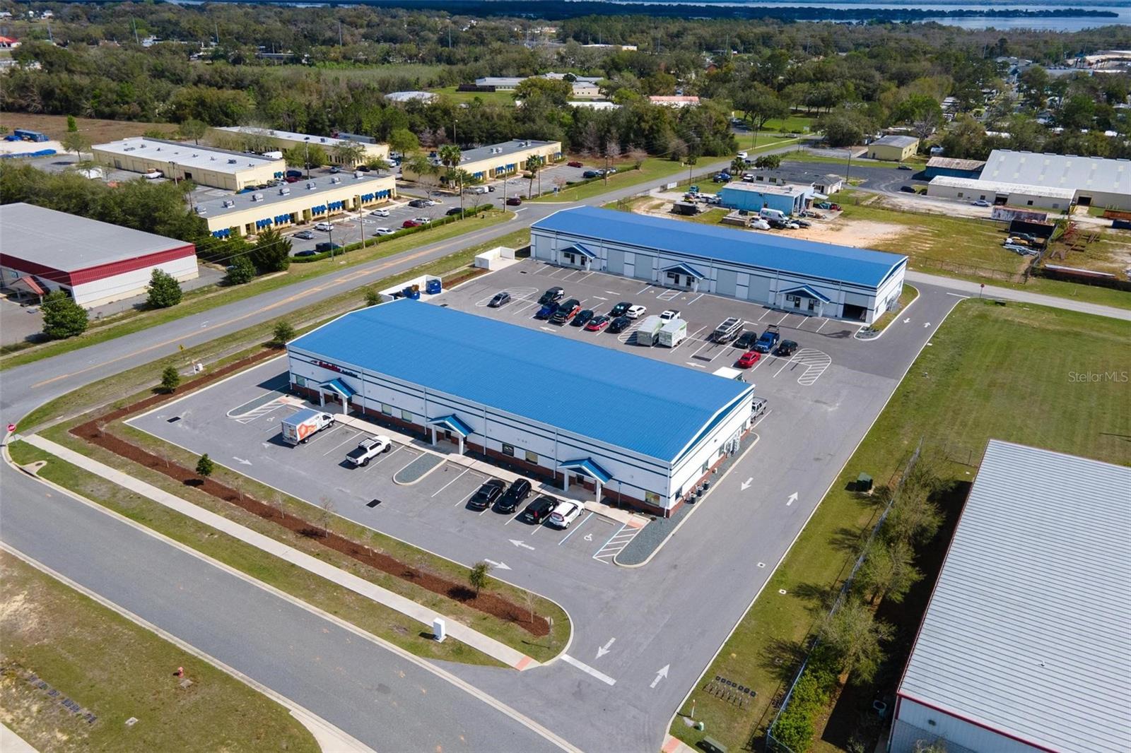 INVESTOR ALERT!!! RECENTLY BUILT & 100% LEASED! TWO EXCEPTIONALLY BUILT BLOCK & METAL OFFICE/WAREHOUSES FOR SALE! Both buildings fully leased with annual rent increases and strong successful tenants. CAP RATE at 6.25% Building 1 consists of 11,696 sq ft and was built in 2021, while building 2 consists of 13,440 sq ft and was built in 2023. Total land size is 2.5+/- acres with 58 parking spaces. Both buildings feature full architectural block exterior walls and metal roofs with well insulated ceilings for maximum energy efficiency. High quality office buildouts in each unit. Great visibility on Tally Rd. Clear span throughout with office area & restroom for each unit, as well as additional restroom in warehouse area for each unit. 12 foot wide x 14 ft tall roll up doors for each unit. Two points of ingress/egress for ease of semi-truck access. High quality, custom construction inside and out in very busy business park well located with easy access and very close proximity to The Villages, I-75 and Turnpike.