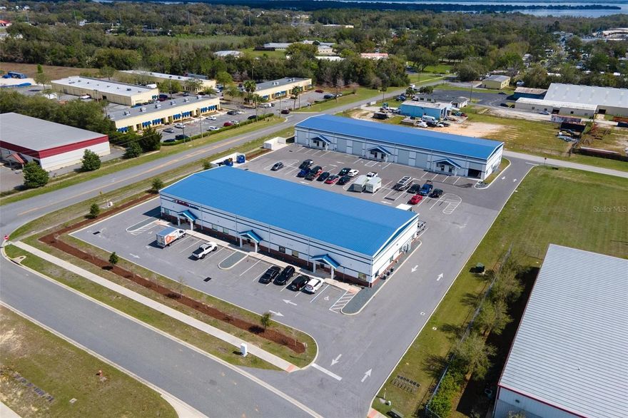 INVESTOR ALERT!!! RECENTLY BUILT & 100% LEASED! TWO EXCEPTIONALLY BUILT BLOCK & METAL OFFICE/WAREHOUSES FOR SALE!  Both buildings fully leased with annual rent increases and strong successful tenants. CAP RATE at 6.25% Building 1 consists of 11,696 sq ft and was built in 2021, while building 2 consists of 13,440 sq ft and was built in 2023. Total land size is 2.5+/- acres with 58 parking spaces. Both buildings feature full architectural block exterior walls and metal roofs with well insulated ceilings for maximum energy efficiency.  High quality office buildouts in each unit. Great visibility on Tally Rd. Clear span throughout with office area & restroom for each unit, as well as additional restroom in warehouse area for each unit. 12 foot wide x 14 ft tall roll up doors for each unit. Two points of ingress/egress for ease of semi-truck access.  High quality, custom construction inside and out in very busy business park well located with easy access and very close proximity to The Villages, I-75 and Turnpike.