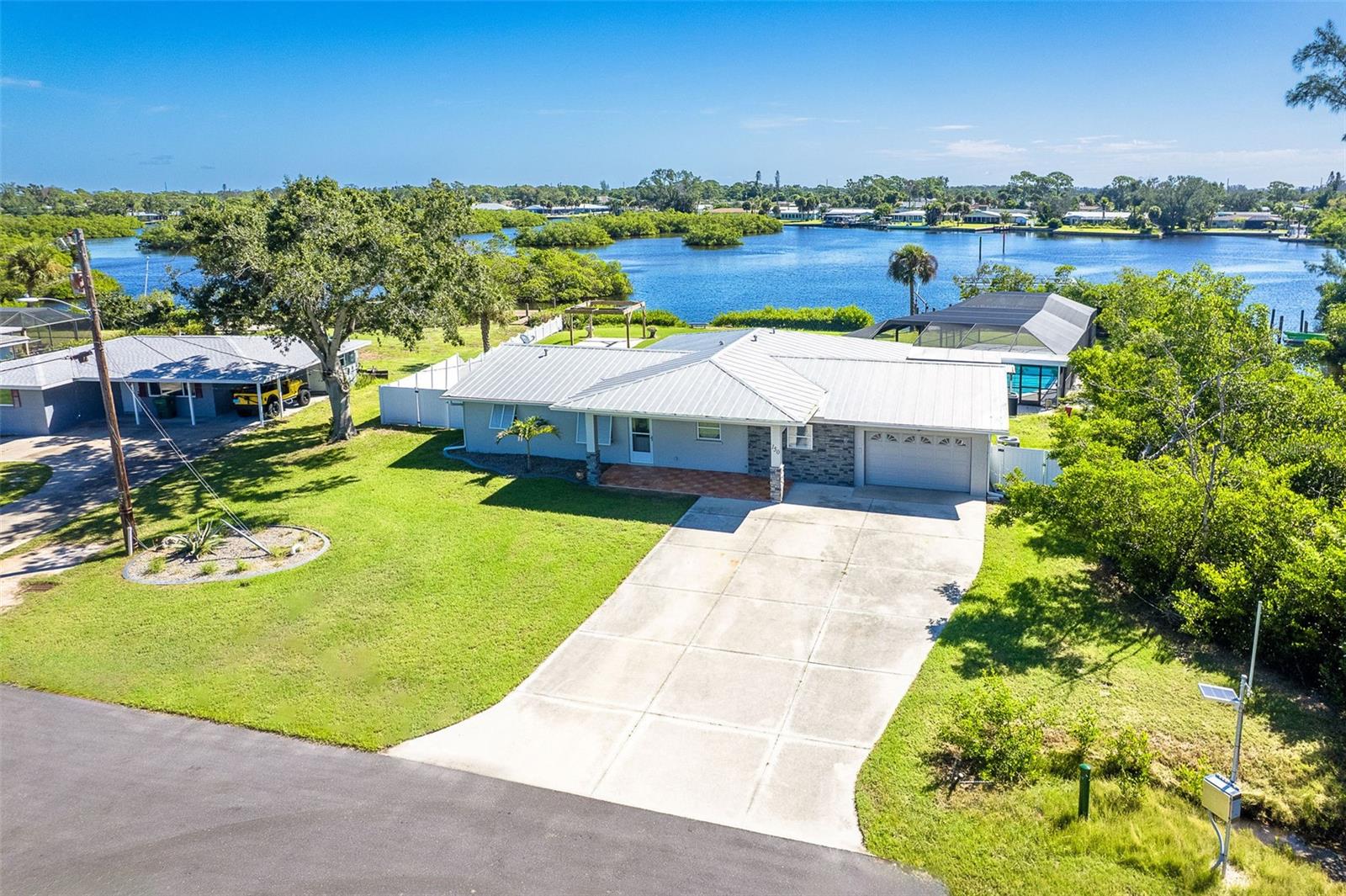 One or more photo(s) has been virtually staged. Welcome to coastal living at its finest. This beautiful 3-bedroom, 3-bath waterfront home is nestled on an oversized lot along scenic Godfrey Creek, offering serene views, exceptional privacy, and direct access to open water with just one fixed bridge. Boaters will appreciate the private dock, perfect for launching sunset cruises or day trips to the Gulf.
Step into your private oasis featuring a oversized in-ground pool and a spacious screened lanai with a full pool bath, ideal for outdoor entertaining. The durable metal roof adds peace of mind, while the open floor plan effortlessly blends indoor and outdoor living.
Located just minutes from Manasota Key and all three of its pristine beaches-Englewood Beach, Blind Pass Beach, and Stump Pass Beach, this home delivers the best of the Florida lifestyle. Whether you're enjoying a quiet morning on the water or entertaining guests in your tropical backyard retreat, 150 Crestview Dr offers the perfect blend of elegance, comfort, and coastal charm.