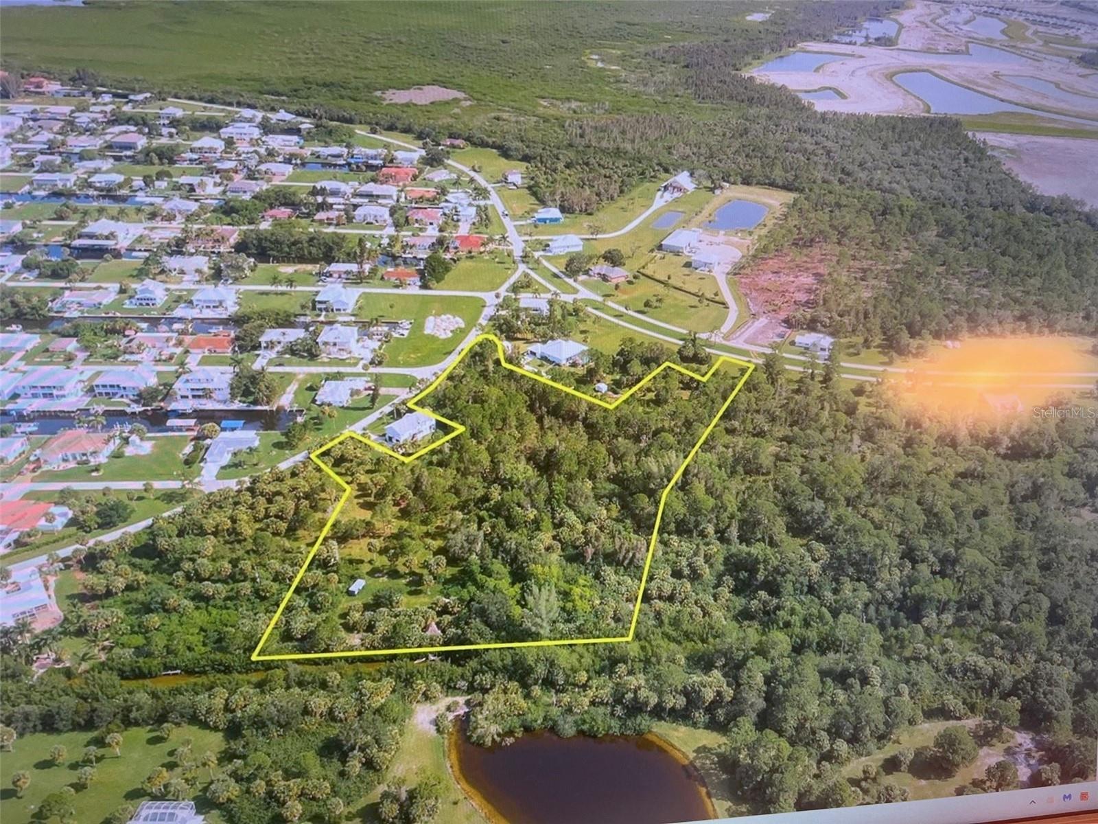 ARE YOU LOOKING FOR WATERFRONT ACREAGE? LOOK NO FURTHUR, THIS LISTING INCLUDES 3 SEPARATE PARCEL'S, addresses are, 24397 Jean La Fitte, 24413/24423 Jean La Fitte & 24511 Yacht Club Blvd. This property is over 5 acres and has approx. 240 feet of water frontage. Property is located in Pirate Harbor, a quiet and friendly community with many new custom homes. Located just south of the town of Punta Gorda along Burnt Store Rd. This waterfront community has several saltwater canals that lead out to Charlotte Harbor. These saltwater canals and Charlotte Harbor are known for some of the best fishing in SW Florida. Community does have public water and sewer available. One of nice things about this area is its close proximity to Burnt Store Marina about 1 mile away. The marina has 2 on-site restaurants, 27-hole executive golf course along with 500+ in water slips also has dry stack storage inside or outside rack storage. On-site boat ramp and other amenities such as tennis and fitness center are available for a fee. If your fished out or just want to relax take a quick ride into the Historic town of Punta Gorda where you will find many shops and restaurants. Lots of activities are held year-round. While you're in town please make a point to visit "Fishermans Village", a great local tourist shopping area with lots of local shops and several waterfront restaurants.