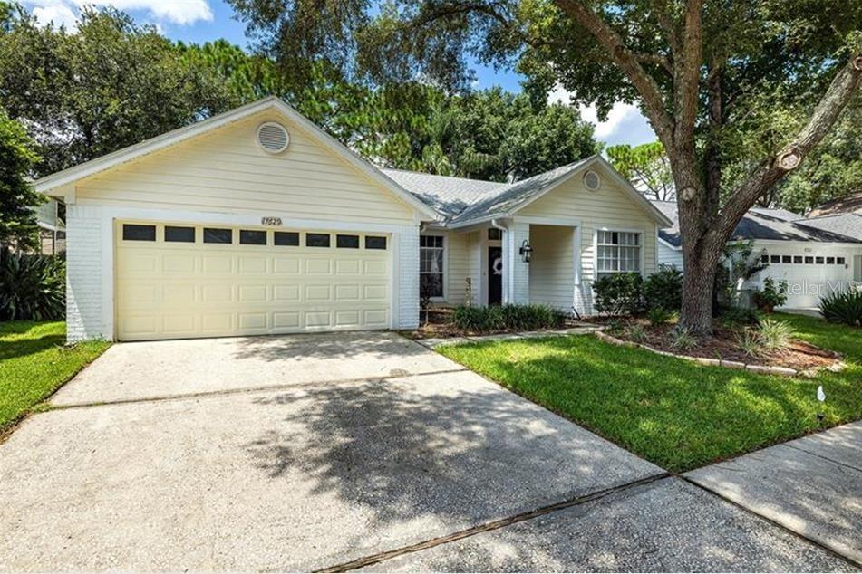 Discover this beautifully maintained 3-bedroom, 2-bathroom single-family rental home in the desirable, guard-gated community of Hunters Green. The 1,401 sq ft interior boasts vaulted ceilings, bright open spaces, and modern appeal with stylish laminate flooring throughout the main living areas. Both bathrooms feature updated vanities, complementing the fresh look. The master suite includes a walk-in closet with built-in shelving. Enjoy the completely fenced backyard and the numerous community amenities, including a fitness center, pool, playground, and tennis courts. Conveniently located near Tampa Premium Outlets, Wiregrass Mall, and dining. Lawn care is included in the HOA. Don't miss this opportunity for resort-style living!