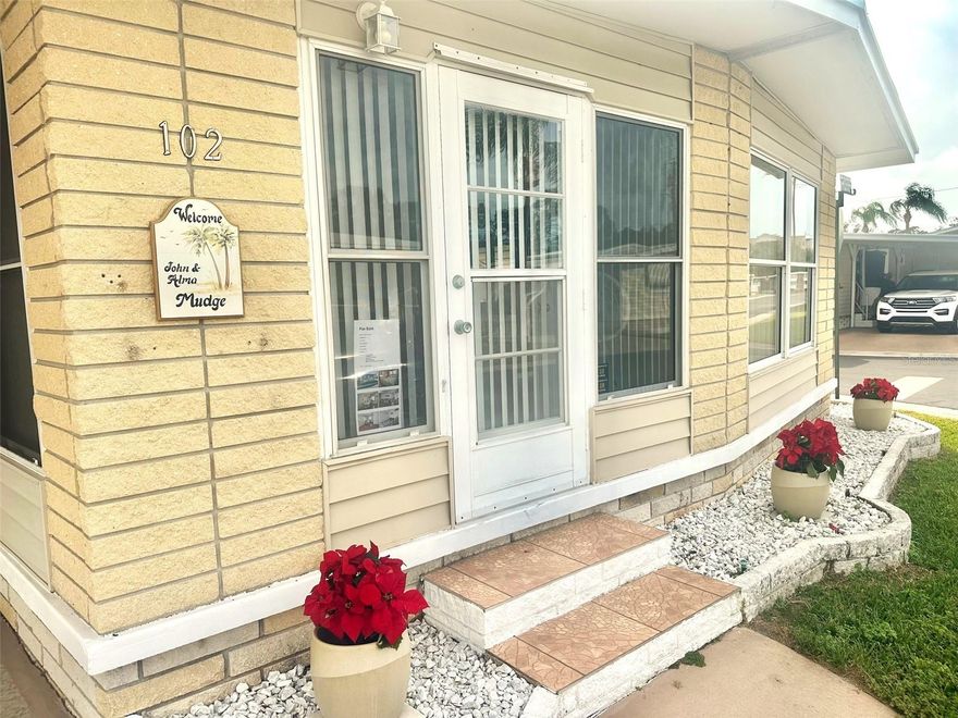 Beautiful & Impressive 2 bedroom, 1 1/2 bath Doublewide, with Front Florida Room to enjoy! Updated Air/Heat Unit '19, & Water Heater '19! Pristine Laminate Flooring throughout, attractive furnishings and new decorator paint to see! Insulated Roof Over, Vinyl Siding and expanded covered parking for 2+ Cars! Bonus newer Washer/Dryer in the spacious 6x11 Workshop/Shed! Inviting fully loaded Kitchen, with new dishwasher, 2 storage pantry's, and lots of storage! Do not wait to see this attractive Florida Resort Inspired Home, on a spacious corner lot, only steps to the large active Clubhouse and pool! Located only minutes away to the golf courses, beaches, shopping plaza, airports, medical and all you would want!  Cash Only! Great Buy!  NOW Asking $118,900, includes the Share! Low $210. mo. fee!