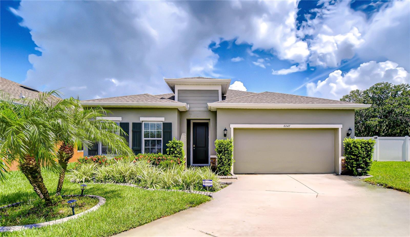 Crisp, clean lines and lush landscaping set the tone for this beautifully upgraded 3-bedroom plus office, 2-bath home located in the desirable Mitchell Ranch South community. Built by Ryan Homes in 2020 and perfectly positioned on an oversized 0.216-acre lot with premium water views, this 2,017 sq ft residence offers a seamless blend of comfort, style, and functionality. Inside, elegant luxury vinyl plank flooring extends throughout the main living areas and primary bedroom. The chef’s kitchen is the heart of the home, showcasing shaker cabinets with crown molding, under-cabinet lighting, a striking glass tile backsplash, granite countertops, GE no-print stainless appliances, and a center island with pendant lighting. Just off the kitchen, a café-style dining area with sliding glass doors overlooks the screened lanai and private backyard—ideal for relaxed mornings and evening gatherings. Retreat to the spacious primary suite with peaceful water views, a generous walk-in closet, and a spa-inspired en-suite bath featuring Quartz countertops, dual under-mount sinks, a split vanity with a central make-up area, and a large glass-enclosed walk-in shower. Designed with comfort and connection in mind, the open family room offers ample space for entertaining or unwinding—framed by serene backyard and water views that create a calming atmosphere. Nearby, a versatile flex room with glass French doors and an upgraded ceiling fan offers endless possibilities as a home office, reading room, playroom, or creative space. The two-car garage includes a utility sink and a water softener system, along with an upgraded electrical package featuring enhanced grounding. Additional exterior upgrades include expanded irrigation, rain gutters with leaf filters, privacy fencing with gates on both sides, floodlights, and mature landscaping—all adding value, convenience, and curb appeal. Situated in Flood Zone X—no flood insurance required—this home is part of a vibrant yet peaceful neighborhood with LOW HOA fees. Enjoy easy access to top-rated Seven Springs Middle and J.W. Mitchell High School, shopping centers, dining, the YMCA, parks, and major roadways including SR-54, Little Road, Trinity Blvd, US-19, and the Suncoast Parkway. Move-in ready and meticulously maintained, this exceptional home is a rare opportunity in a sought-after location. Schedule your private tour today and discover the lifestyle that awaits at 8847 Prairie Creek Drive.
