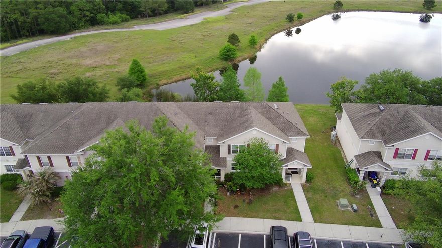 One or more photo(s) has been virtually staged. Welcome to this 4-bedroom, 3-bathroom townhome in Kissimmee, ideally located just about 20 minutes from Walt Disney World. This home offers a functional layout with a full bedroom and bathroom on the first floor, perfect for guests, extended family or added flexibility. Inside, you’ll find brand new carpet throughout the living areas and bedrooms, tile flooring in all wet areas and a clean move-in-ready freshly painted interior. The kitchen is equipped with stainless steel appliances and opens to the main living space, making it easy to entertain or stay connected. Open your sliding glass door and enjoy a screened-in lanai overlooking the pond, an ideal spot to relax and/or unwind with no rear neighbors. This amenity-rich community offers something for everyone, including a resort-style pool and spa, outdoor basketball, sand volleyball, a 50 seat movie theater, game room, playground, clubhouse & dock to walk across and enjoy the water views. Whether you're looking for a primary residence, vacation home, or an investment opportunity, this property checks all of the boxes.