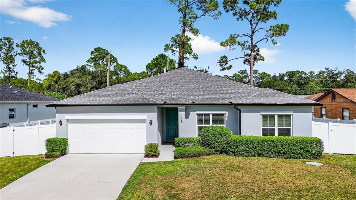 Built in 2023, this stunning 4 bedroom, 3 bathroom home combines contemporary design with everyday comfort, all just minutes from the beach, shopping, dining, and entertainment. Step inside to find an open floor plan with soaring ceilings, abundant natural light, and stylish finishes throughout. The gourmet kitchen features granite countertops, stainless steel appliances, and a large island—perfect for entertaining or family gatherings. The spacious primary suite offers dual walk-in closets and a spa-like bath with two vanities, and walk-in shower. With three additional bedrooms and two more full baths, this home provides plenty of space for guests, family, or even a home office. Enjoy Florida living year-round with a covered patio and private backyard, ideal for outdoor dining, barbecues, or simply relaxing in the sunshine. Don't miss the opportunity to own a brand-new home in a prime coastal location!