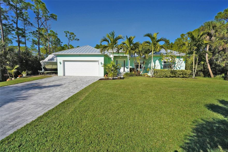 Fantastic pool home set in a private tropical setting. This well-maintained 3BR split plan features a spacious primary suite with his-and-hers walk-in closets, a large bathroom with garden tub, and a separate walk-in shower. Home offers energy-efficient double-pane windows and custom plantation shutters. Metal Roof for years of maintenance free living. Upgraded water system includes a peroxide injection filtration system plus reverse osmosis at the kitchen sink and refrigerator. Kitchen features granite counter tops and all appliances. Enjoy the screened back porch overlooking a screened pool with waterfall. Additional outdoor features include a small wood deck, separate portico, custom equipment shed with deck and fire pit, and RV/boat parking area. One-acre lot with mature tropical landscaping and a full sprinkler system. Paver driveway completes this private tropical oasis.