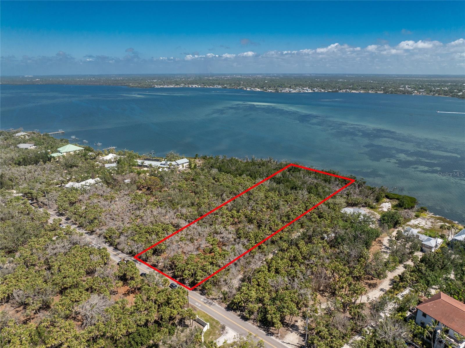 Boaters, build your dream home on this exceptional 2.9-acre bayfront lot, priced at $2.9 million, with 200 feet of frontage on Lemon Bay in the coveted Manasota Key area of Sarasota County. Located on a quiet, two-lane road with no stop signs, traffic lights, condos, or high-rises, this spacious property offers a tranquil and picturesque setting perfect for those seeking privacy, space, and luxury living. Surrounded by other large-lot single-family homes, this rare property allows you to design a waterfront estate with direct boating access to the Intracoastal Waterway and the Gulf of Mexico, ideal for exploring Southwest Florida’s world-class fishing and boating destinations. Enjoy watching dolphins, manatees, and seabirds right from your dock while taking in spectacular sunrises over Lemon Bay. Just across the street, miles of pristine Gulf beaches await for swimming, shelling, or simply relaxing. Minutes away, Englewood offers a welcoming small-town coastal vibe with charming local restaurants, live music, art galleries, farmers markets, and everyday conveniences, all while maintaining its laid-back, Old Florida character without the crowds of larger tourist areas. Conveniently located only 50 minutes south of Sarasota, 90 minutes to Tampa or Fort Myers airports, and 50 minutes to Punta Gorda Airport, this rare slice of paradise on Lemon Bay is truly precious and will not last long — contact us today to make it yours.