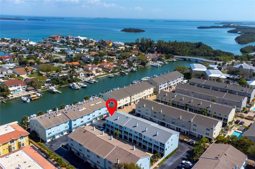 Welcome to island living at its finest in the desirable TIERRA SAILS community of Tierra Verde. This beautiful three-story, TURN-KEY (drop your bags and head to the beach!), FULLY FURNISHED END UNIT, offers nearly 2100 sq ft of spacious living with 3 bedrooms, 2.5 bathrooms, and a 2-car oversized garage, perfectly blending comfort and coastal charm. CAN ALSO BE SOLD UNFURNISHED.
The main living level (second floor) features an open concept floor plan with rich wood flooring, a custom travertine wood-burning fireplace, and sliding glass doors that lead to a screened balcony- ideal for enjoying the island breeze. The spacious designer kitchen offers granite countertops, abundant cabinetry, a breakfast bar and built-in desk making it both functional and perfect for entertaining. A convenient powder room completes this level. 
Upstairs, the primary suite provides a relaxing retreat with oak flooring, a spa-style bathroom with dual vanities, whirlpool bath, separate shower and private water closet. Two additional bedrooms share a recently updated full bathroom, and the laundry area is conveniently located on the same level. On the ground level, enjoy an additional screened patio just off the oversized garage, which is perfect for storing beach gear, bikes and all your favorite “toys”. Residents enjoy access to a HEATED community pool. This property has been historically well-maintained with a brand-new roof and complete replumbing/repiping as of 2025. Pet friendly community.
Located directly across from the shops and restaurant of downtown Tierra Verde and just minutes from the award-winning beaches and natural beauty of Fort De Soto Park, the highly thought after Isla Del Sol Yacht and Country Club (membership required), this home offers the best of Florida coastal living. Easy access to I-275 and bustling downtown St. Petersburg. Less than 10 minutes' drive to acclaimed Gulf Beaches, Don Cesar Hotel, 30 minutes to Tampa and St. Petersburg/Clearwater International Airports.