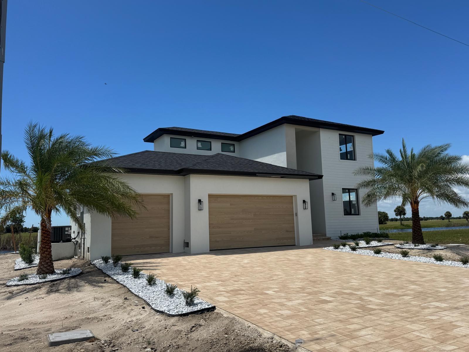 Under Construction. Experience Modern Lakeside Luxury . Introducing a stunning new construction home that blends modern elegance with serene water views. Boasting 2,118 sq. ft. of thoughtfully designed living space, this two-story dream home features 3 bedrooms, 2.5 bathrooms, a pool, and a spa all designed to immerse you in lakeside living.
The master suite, conveniently located on the first floor, provides seamless access to the living area, kitchen, and the outdoor pool area . It boasts a spacious walk-in closet and a spa-inspired master bath with a walk-in shower and dual sinks. The first floor also includes a versatile den, ideal for a home office or creative workspace. The Second-Floor Retreat Upstairs, two guest bedrooms offer the perfect combination of privacy and comfort—ideal for family or visitors.
Inside, you'll find sleek porcelain tile flooring throughout and kitchen with stunning waterfall quartz countertops and premium appliances. Every element has been thoughtfully selected to elevate your living experience. Impact-resistant windows enhance safety and peace of mind, while high ceilings and elegant quartz finishes exude sophistication. Meticulously crafted details throughout the home provide comfort and contemporary style.
Don’t miss your chance to own this extraordinary lakeside haven—it's a masterpiece waiting to be called home.
