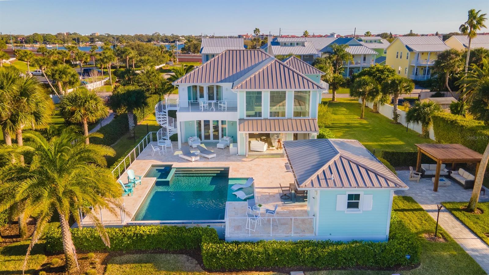 Custom built 4 bedroom, 5.5 bath riverfront home with 120’ of waterfrontage, deep water dock and fabulous pool on half an acre. The main home features open floorplan that provides spectacular views from many vantage points. Three sets of folding impact doors allow seamless opening between the great room and the travertine covered lanai, salt pool and spectacular views of the canal and Intracoastal. Well-appointed kitchen with waterfall quartz counters, six burner gas range, pot filler, glass butler’s pantry and plentiful cabinetry. Master suites up and down, both with luxurious baths and soaking tubs. Luxury plank flooring throughout with porcelain tile in wet areas. Main home includes 3 bedrooms, 3.5 baths. Open concept floating mahogany stairs lead to upper level family room, second master, guest bedroom/bath and private covered and uncovered balcony with amazing views. The 4th bedroom is in a separate guest house suite with full bath and kitchenette. Enjoy alfresco dining under the cabana with summer kitchen and pool bath. Salt pool with swim shelf and fire bar. Lush landscaping surrounds the fire pit and lounge area. Covered dock with lift and floating dock. Offered fully furnished, this home has been built to the highest standards with top quality materials including impact windows, concrete construction on both levels, 17 foot underground pilings and standing seam aluminum roofs. Natural gas for range, outdoor kitchen, 2 tankless water heaters, dryer, fire pit, fire bar, tiki torches and spa. Sprinkler system uses reclaimed water. Custom furnishings, window treatments and decor throughout. There’s a lot of yard for kids, pets, extra toys and more. Great location just half a mile to Flagler Avenue. Qualified showings by advanced appointment only please. ;Water: City