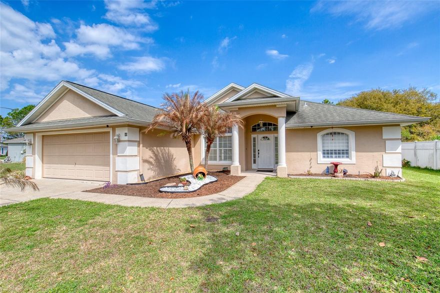 Immaculate, move-in ready custom home in the highly desirable Palm Harbor neighborhood of Palm Coast -- set on an oversized lot with plenty of room to add a pool or create your dream outdoor living space. Step inside to an elegant columned entry and bright open floor plan with volume and tray ceilings, arched windows and doorways, and a formal dining room. The split bedroom layout offers privacy: 3 bedrooms, 2 baths, a spacious living room, breakfast nook and an updated kitchen with new stunning granite countertops. The primary suite is a relaxing retreat w/ 2 walk-in closets, a spa-like bath featuring separate vanities, garden tub and a tiled walk-in shower. Outdoor living is effortless -- sliders from the living room & primary suite open to a covered screened porch, perfect for morning coffee or evening sunsets. Practical upgrades include a sprinkler system on a well, epoxy floors in garage and back porch, termite baiting system, and gutters w/ rain diverting system to back yard.