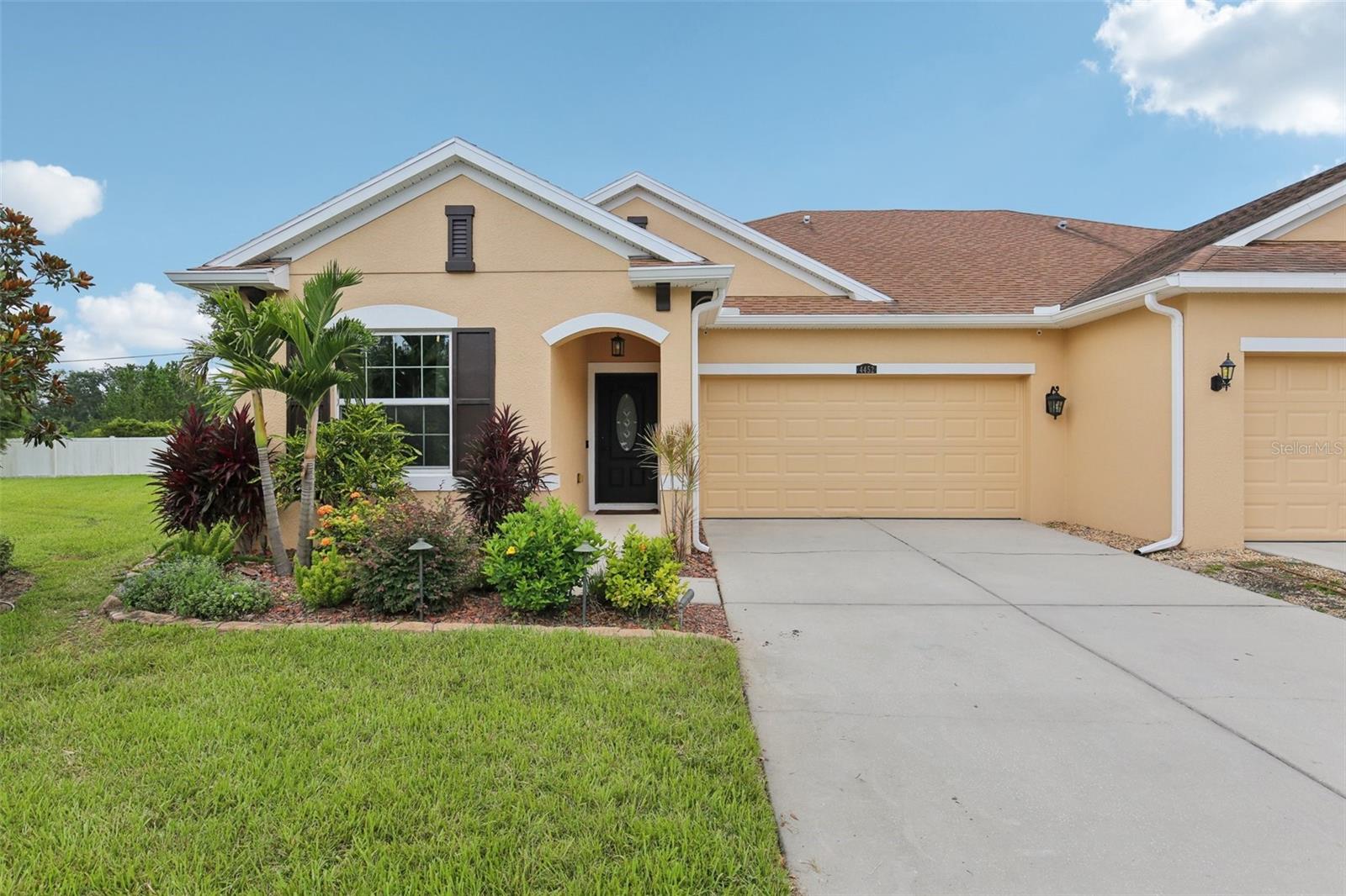 Move-In Ready Villa with Designer Finishes in Ashton Oaks! Located on a quiet cul-de-sac, this beautifully upgraded 3-bedroom, 2-bath villa offers the perfect blend of style, comfort, and low-maintenance living. The home features tile flooring throughout, fresh interior paint, and an open-concept layout that includes an oversized enclosed sunroom with two ceiling fans and a portable AC unit—ideal for year-round enjoyment. Just beyond the sunroom is an additional paver patio and a fully fenced backyard, perfect for outdoor relaxing or entertaining. The kitchen is a standout, featuring antique white glazed cabinets with upper and lower crown molding, granite countertops, a center island with pendant lighting, stainless steel appliances including a double oven, under-cabinet lighting, and a reverse osmosis water filtration system. Both bathrooms mirror the kitchen’s upscale finishes with matching cabinetry and granite counters. The spacious primary suite includes a walk-in closet with built-in organizers, plantation shutters, a charming wood accent wall, and an en-suite bathroom with dual sinks and a large walk-in shower. Additional upgrades include inside laundry with washer and dryer, an epoxy-coated garage floor, utility sink, three overhead storage racks, EV charging pre-wiring, a 2021 HVAC system, a brand-new water heater (2024), whole-home water softener, and a Swann video camera security system. The HOA covers lawn care, roof replacement, and exterior painting, allowing you to enjoy truly maintenance-free living. No CDD fees! Community amenities include a pool, and the location offers convenient access to shopping, dining, and top-rated schools. This villa checks all the boxes—don’t miss your chance to make it yours!