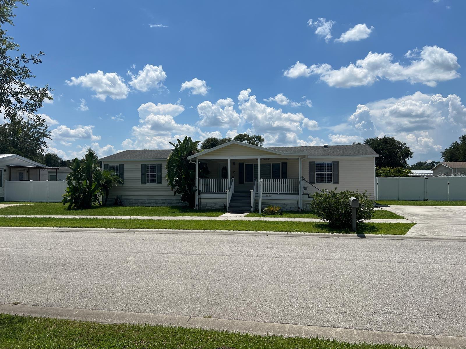 Welcome to your next home at Terrace Park Phase III. This community is nestled between Wesley Chapel and Zephyrhills. Seat on your front porch of your 3-bedroom 2 bath split bedroom plan, with a renovated kitchen including granite countertops, stainless steel appliances and laminate flooring throughout the home. Open concept between kitchen, dining room and living room for entertaining. The split bedroom plan offers the Master Bedroom at one end of the home with a walking closet and easy access to the updated master bathroom with new fixtures, granite countertop with a double sink vanity and a brand new shower and tub combo. The second and third bedrooms are located at the opposite end of the home, have walk-in closets, and easy access to the guest bathroom. The laundry room is located just off the kitchen inside the home. This home also includes a covered screened patio lanai (12 x 16) with pressure treated wood flooring for entertaining. Enjoy your backyard privacy with vinyl fencing and a 1 car garage / storage (12 x 24) with 110/220 voltage outlets also ready for recreational vehicles. The home has a brand-new A/C unit that was installed in July 2022. The home is across SR 54 from the now under construction of Avalon Park Downtown Wesley Chapel (avalonparkwesleychapel). Close to home improvement stores, supermarkets, shops and restaurants.