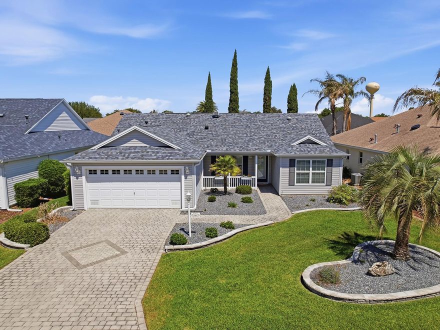 Just above Lake Sumter Landing Square and a stone’s throw from 466 in The Village of Winifred, this beautifully appointed Bougainvillea model captures the effortless lifestyle that makes The Villages a destination for active adults. The neighborhood pool is right down the road, and the nearby shopping, dining and entertainment hubs mean convenience is never far from your front door.

Coming onto the paved driveway you’ll be greeted by a meticulously landscaped front yard, complete with a clean line of gutters that frame the home’s low-maintenance curb appeal. A welcoming entry opens into an airy great-room where vaulted ceilings draw the eye upward and crown molding adds an elegant touch to the open-concept layout. Natural light pours in through a solar tube, while the removed lanai slider reveals a glass-enclosed lanai/ Florida Room—a perfect, weather-proof retreat for morning coffee or evening drinks, overlooking the backyard.

The heart of the home is the kitchen, where custom cabinets, recessed lighting, granite countertops, black appliances and a tiled backsplash create a sophisticated backdrop for culinary adventures. The convenient eat-at bar invites casual meals and conversation. Flowing seamlessly from the kitchen, the living area extends to the dining space, all anchored by seamless laminate flooring that unites the main living zones.

Retreat to the primary suite, where a freshly redone shower with a Jetta-stone enclosure and tasteful glass doors. Cherry and granite finishes are found here, adding warmth and texture to the space. Two additional bedrooms feature plush carpet, while a guest bathroom boasts granite accents and a thoughtfully designed vanity. Practical touches abound—a laundry room equipped with an abundance of cabinets for organized storage, an epoxy-finished garage that resists wear, & custom-designed landscape.

Every detail of this home has been crafted for comfort, style and low-maintenance living, making it an ideal sanctuary for those who want to savor the vibrant social scene, world-class amenities, and endless recreation that The Villages provides—all while enjoying the peace and privacy of a beautifully appointed residence. Be sure to come take a look at this fabulous home today :-)