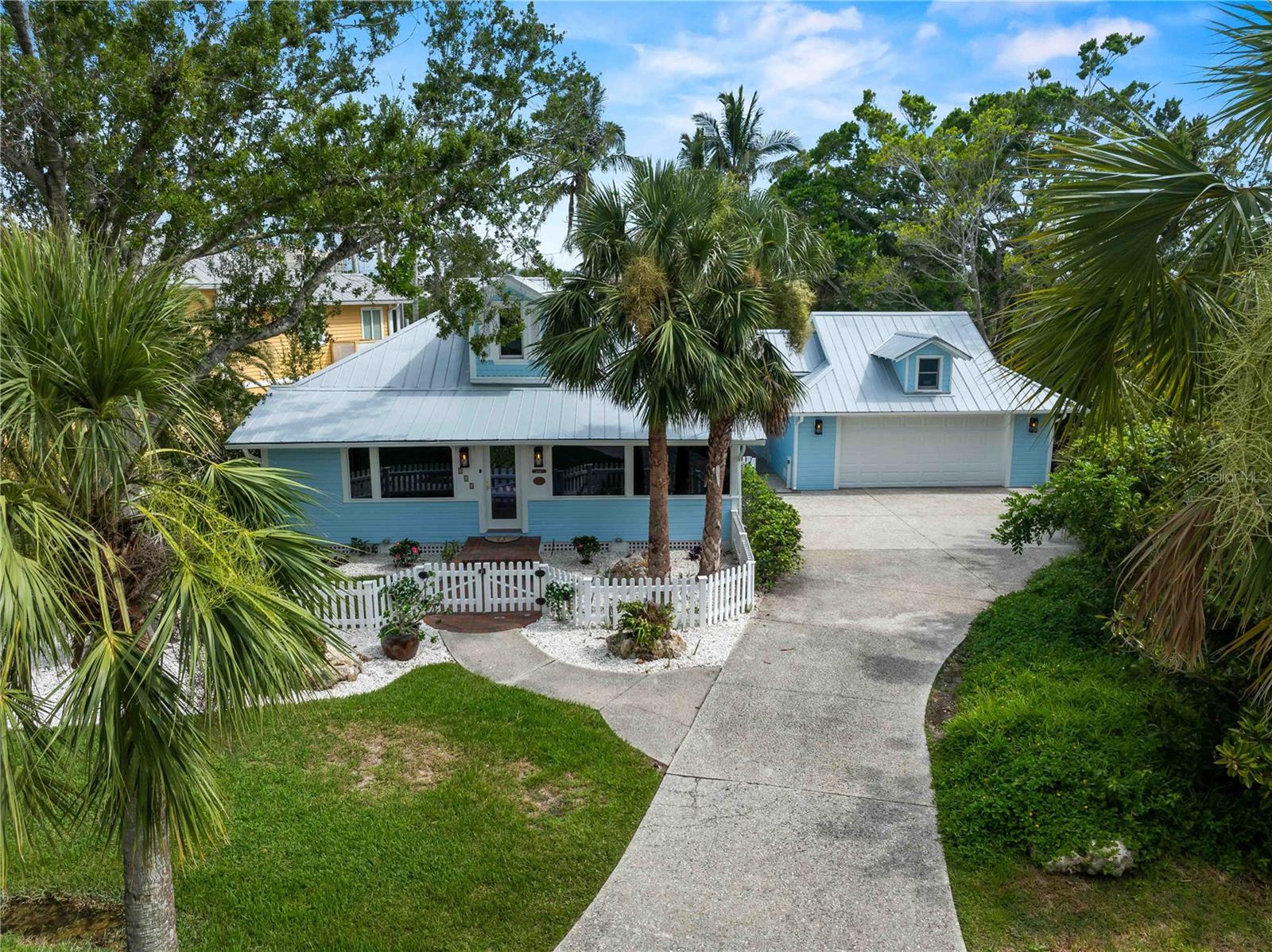 Take a walk back in time to 713 Eagle Point Drive. This is Old Florida at its finest built in 1917. This Home is on the register of National historical places in Florida. Eagle Point neighborhood once was a private hunting and fishing resort for wealthy developers, railroad and business tycoons and now is a lush oasis just a half a mile to downtown Venice for all of your shopping and dining desires. This charming waterfront 2 bed 2 1/2 bath home checks all the boxes with a new 30’ dock slip underway on the sailboat water of Robert’s bay which is a short straight out ride to the Gulf of America!
This home just underwent a complete post hurricane renovation with all new designer touches to every room , the master bathroom looks straight out of a magazine. Original heart Pine floors throughout freshly refinished , new chef’s kitchen sure to impress. Everywhere you look in this house including the garage has a special touch.
Vaulted living room and kitchen ceilings gives a light airy feel. This home comes furnished, professionally decorated turnkey ,no hassle just bring your suitcase. If you have a big family, you’re in luck! The historic clubhouse, dating back to 1916, adds a touch of nostalgia, and residents can accommodate overflow guests in the 3-bedroom cottage or 4-bedroom clubhouse , sleeping 14+, for neighborhood use only. Homes in this very exclusive and very welcoming neighborhood do not come up for sale very often, don’t miss your opportunity to own a piece of historic paradise.