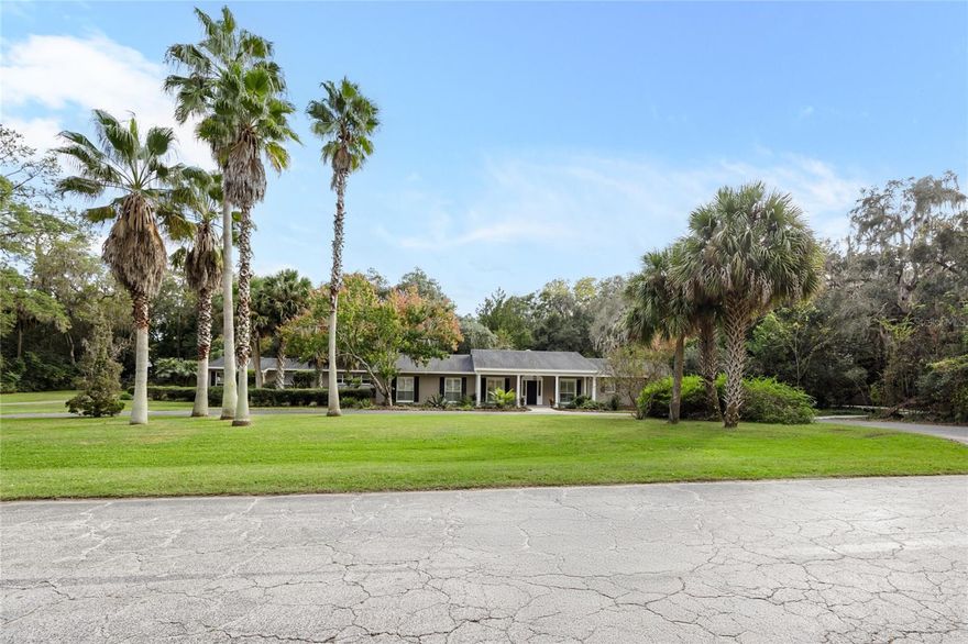 Lifetime Home Located in Beautiful 2 Acre Park-like Setting with Attached Fully Equipped Apartment! The main home offers 4,327 sq ft 4 full bedrooms and 3.5 bathrooms with additional hidden study off owner's suite and additional bonus/play room adjacent to the pool half bath and kitchen all on one  level and fully open to the enormous screened in pool & spa area. The spacious kitchen with wood cabinetry and granite countertops features a Thermador gas range & wine fridge and is open to the massive family room with double sided gas fireplace. This custom designed all block home built by M.M. Parrish Construction for E.T. York features an impressive circular drive entry with long side driveway and rear entry 3 car covered carport. One bedroom 750 sq ft apartment offers full kitchen, living area, updated bathroom with shower, and bedroom. Concrete sidewalk wraps around the entire oak-laden property along with chain link fencing allowing separate space for pets. Kenwood is located in desirable SW Gainesville and is a convenient location to schools, shopping, & bus routes to UF and hospitals. Per Alachua County records: Roof 2017, whole house repipe 2017, 2018 tankless gas water heater, 2020 HVAC, septic tanks replaced/new drainfield in 2023.