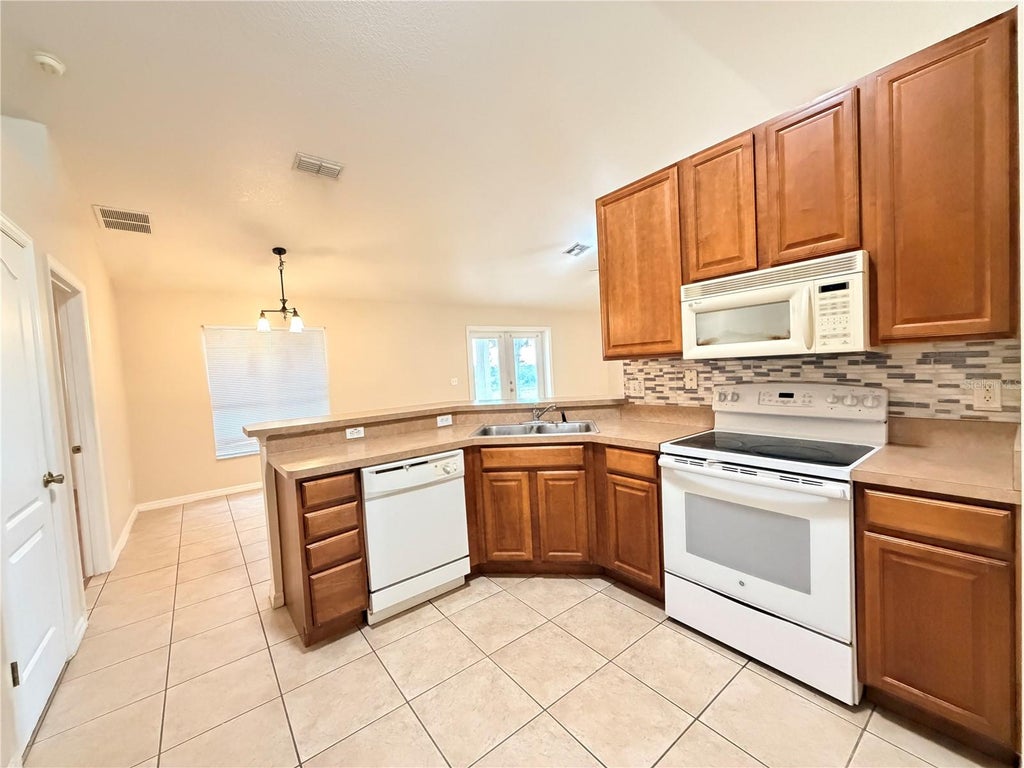 Photo of 10438 Vista Pines Loop, Clermont, FL 34711 (MLS # O6436717)