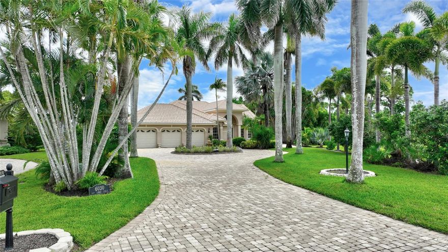 This home is located in the exclusive community of Admirals Point in the largest Florida west coast marina called Burnt Store Marina.  The home sits on over one-half acre of meticulously maintained landscaping which features 15 Cuban Royal Palms along with over 25 mature Foxtail Palms.  The entry to the estate is on a cul-de-sac with a circular paver driveway featuring an island with a fountain.  The home has a large 3-bay garage with hurricane rated 195 mph doors with windows.  Upon entry to the home through double lead framed windows, you will be at awe when you see the beauty of this professionally designed one-of-a kind home.  Interior features include a private dining room with a vaulted double tiered lighted ceiling and a Butler's Entry to the kitchen.  The recently updated kitchen has GE Slate appliances, Quartz counters, and towering planter shelving.  There is also a hanging tower over the bar that separates the kitchen with the great room.  Your eyes will immediately focus on the most unique feature of the home, that being an atrium which is landscaped with tropical plants surrounding a pond with a fountain.  The atrium has a screened opening in the ceiling to allow natural light along with rainfall to replenish the pond.  The home has a large primary bedroom along with two additional bedrooms at opposite ends of the home.  Adjacent to the great room are pocketed sliders leading to the massive lanai/pool area encompassing 2165 square feet of tropical beauty overlooking a lake and golf course view.  In order to see all this home has, you must come take a look.  Centrally located in the marina, the home also adds a great deal of privacy in that while sitting in the lanai, you cannot see a neighbor's home on either side.  Burnt Store Marina lies on the eastern coast of Charlotte Harbor.  In that Charlotte Harbor is the second largest estuary in the State of Florida, coupled with its proximity to the Gulf of America, it's no surprise that Burnt Store Marina is a mecca for boating and fishing enthusiasts.  Whether your pleasure draws you to family fun cruising, speedboating, sailing, world class fishing, or dolphin and manatee sightseeing excursions, there is truly something for everyone to enjoy on the water.  In addition, there are many amenities that include a fitness center, tennis, pickle-ball, swimming pools, worldclass fishing, a private yacht club, along with golf and waterfront dining.  These are a few of the many treasures that await you.  Imagine living in a community with a lifestyle where yachters and nature enthusiasts mingle with golfers and tennis players to create a buzzing, active neighborhood of residents, each of whom is proud to call Burnt Store Marina their home.