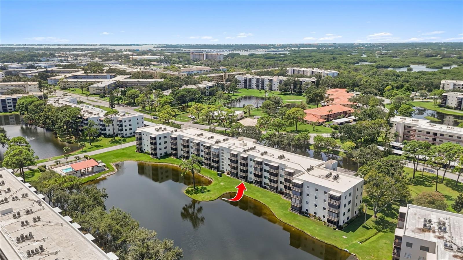 Discover comfort and convenience in this beautifully maintained first-floor condo, offering 2 bedrooms, 2 bathrooms, and serene pond views in the sought-after 55+ community of Five Towns. This move-in ready home is in a building with a new roof for added peace of mind. Inside, the owner’s suite offers plenty of storage with three closets and an ensuite bath with a walk-in shower. The second bedroom and full bath are perfect for guests or a flexible home office. The kitchen features a brand-new dishwasher and a gas stove, while the open living/dining area is filled with natural light. A sliding glass door leads to your screened lanai with tranquil pond views. You’ll appreciate the easy-to-maintain engineered hardwood floors in the living areas and bedrooms, paired with tile in the kitchen and bathrooms. Five Towns provides a lifestyle to love, featuring two clubhouses, six swimming pools, tennis courts, and more—perfect for those seeking both relaxation and activity.