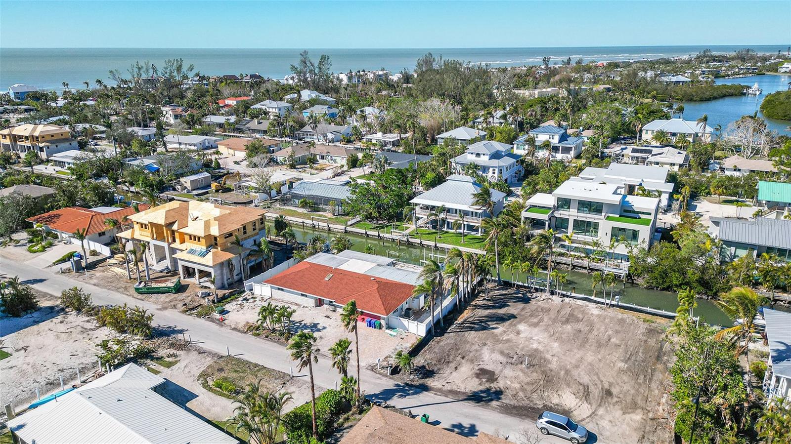 Welcome to an incredible opportunity in the highly sought-after Bayview Estates on Longboat Key. Situated on a stunning saltwater canal lot with direct access to Sarasota Bay and the Gulf of Mexico, this property is a boater's paradise. Featuring a deep-water canal with a dock, seawall, and lift already in place, the potential for creating your dream waterfront home is limitless. Enjoy peekaboo views of the bay and imagine the possibility of expanding or redeveloping the property to take in breathtaking vistas of Bishops Bayou, the Intracoastal Waterway, and beyond. This home is located just steps from the public beach access, offering unparalleled convenience to one of Longboat Key's best surf breaks. Nearby amenities include fine dining, shopping, tennis, fitness clubs, and community parks, ensuring the quintessential island lifestyle. While the home was damaged and flooded during recent hurricanes, it presents a fantastic opportunity for visionaries to rebuild or renovate and make it their own. Being sold for land value, this property is your chance to create a dream residence in one of Longboat Key's most coveted neighborhoods. Don’t miss out—schedule your private tour today!