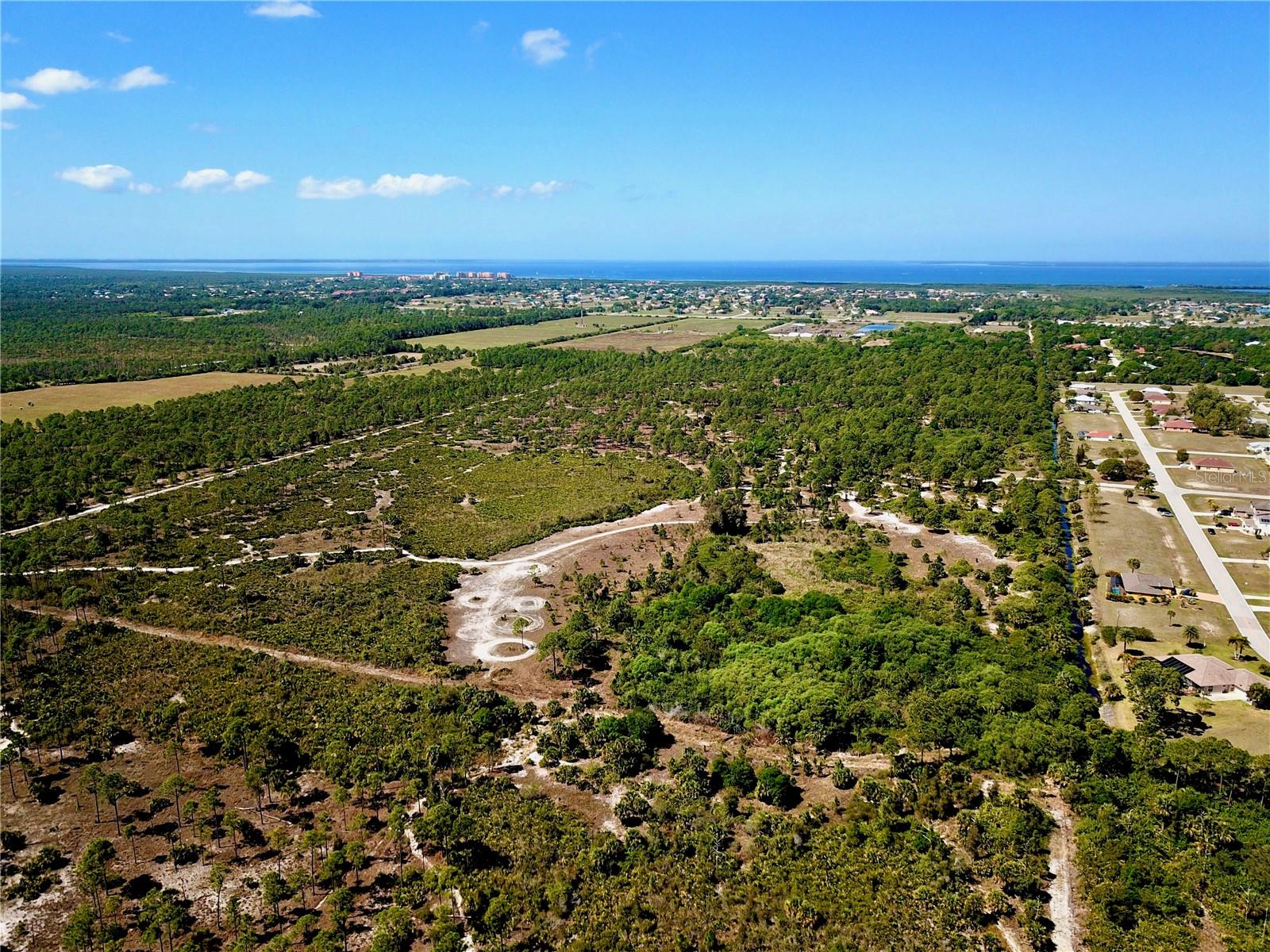 This property consists of 80 acres of residential land located just off of Burnt Store Road in Punta Gorda. It's currently zoned PD (Planned Development) with approval for up to 270 townhouses. There are utilities to the site and there is a lift station along the northern boundary. It is located in a growing area as there are multiple new developments occurring within Burnt Store Village and Punta Gorda.
The property is located at 17050 Burnt Store Road in Punta Gorda in Charlotte County. It's adjacent to the Woodlands Estates community. Access is provided by taking Harborside Blvd. from Burnt Store Road.
The property is centrally located as it's only 10 minutes to US 41 and less than 15 minutes to I-75. It's also in close proximity to Cape Coral (10 minutes), downtown Punta Gorda (15 minutes), Fort Myers (20+ minutes), and it's only an hour to Naples & Sarasota.