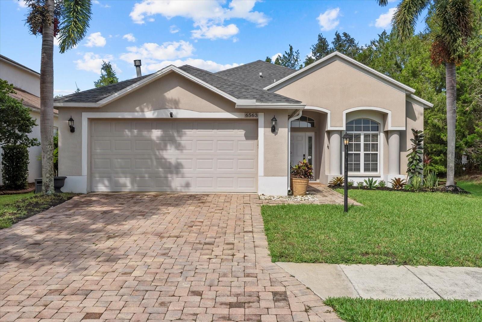 Welcome to 6563 Blue Grosbeak Circle—where comfort, value, and Florida fun come together in the heart of Lakewood Ranch! This well-crafted Bruce Williams home features 3 bedrooms, 2 bathrooms, and a dedicated den/office, all within a thoughtfully designed layout that’s perfect for everyday living and effortless entertaining. In the heart of the home is where you'll find the brand-new, designer kitchen (2023) featuring quartz waterfall countertops, gas cooking, a breakfast bar, and a separate coffee bar. The kitchen flows into the dining room with a charming window seat and into the spacious living room featuring a custom built-in entertainment center. From there, the home opens up to an outdoor space that truly steals the show. Get ready to be impressed—this home offers one of the most exceptional outdoor living spaces you’ll find. The heated saltwater pool and spa are surrounded by a spacious brick paver patio, featuring a covered lanai for lounging and a second outdoor seating area complete with your very own Tiki bar. Whether you're hosting a pool party or enjoying quiet evenings under the stars, this backyard delivers unbeatable Florida living. Lush landscaping offers both beauty and privacy, while the fully fenced backyard on a corner lot expands the space for outdoor games, pets, or simply soaking in the peaceful surroundings—truly your own private resort. The split-bedroom floor plan offers both comfort and functionality, with two guest bedrooms and a full bath located off their own private hallway. The primary suite is thoughtfully positioned for privacy and includes lanai access, a large walk-in closet, and a spa-like en-suite featuring dual sinks, a walk-in shower, and a relaxing soaking tub. Additional updates include a new roof (2022), AC system (2020), pool heater (2020), pool pump (2020), and new backflow preventer (2024). Located in Greenbrook and zoned for top-rated McNeal Elementary, Nolan Middle, and Lakewood Ranch High, this home also offers access to bike and walking trails, community parks, playgrounds, dog parks, ball fields, and more. With low HOA fees of just $115/year and a prime location minutes from shopping, dining, and Lakewood Ranch Main Street, this home is packed with value and ready to enjoy—schedule your showing today!