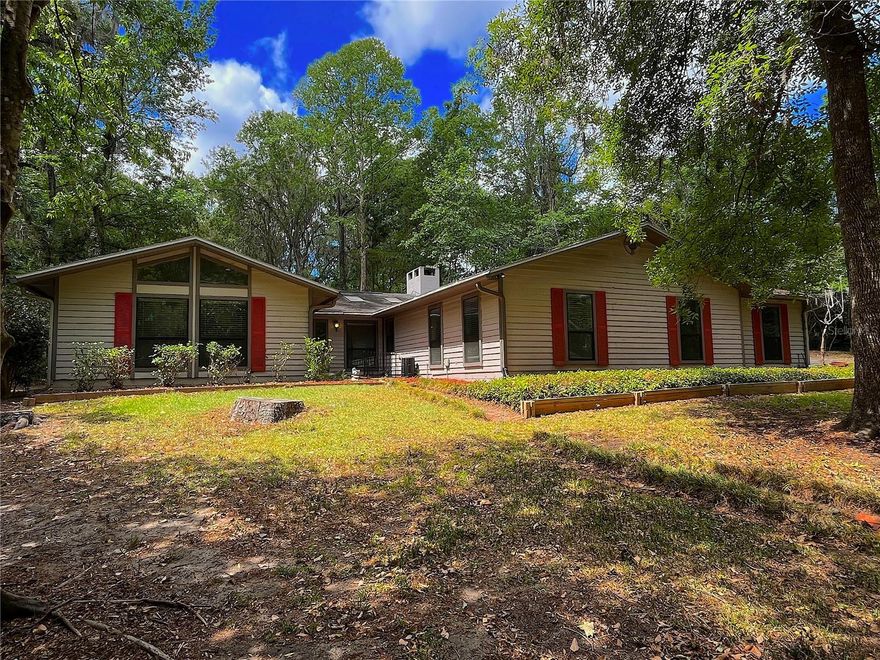 Check out this beautiful 4 bedroom, 2 bathroom home located in the heart of Gainesville! The spacious living room features vaulted ceilings and a cozy wood-burning fireplace, perfect for relaxing evenings. The updated kitchen offers wood cabinetry, granite countertops, and stainless steel appliances. Enjoy wood and tile flooring throughout, making maintenance easy. This home also features newer double-pane windows, a newer roof and newer HVAC for improved energy efficiency and lower utility costs. The primary suite stands out with a stunning tongue-and-groove ceiling, while both bathrooms have been tastefully updated. A 2-car garage provides plenty of space for storage and recreational items. Step outside to a private backyard and enjoy your morning coffee on the screened-in porch. Conveniently located just minutes from North Florida Regional Hospital and less than 15 minutes to downtown Gainesville, the University of Florida, and Shands. Schedule your private showing today—this home won’t last long!