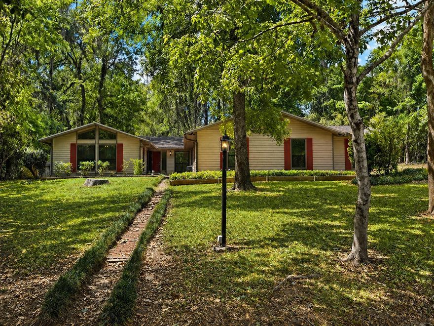 Check out this beautiful 4 bedroom, 2 bathroom home located in the heart of Gainesville! The spacious living room features vaulted ceilings and a cozy wood-burning fireplace, perfect for relaxing evenings. The updated kitchen offers wood cabinetry, granite countertops, and stainless steel appliances. Enjoy wood and tile flooring throughout, making maintenance easy. This home also features newer double-pane windows, a newer roof and newer HVAC for improved energy efficiency and lower utility costs. The primary suite stands out with a stunning tongue-and-groove ceiling, while both bathrooms have been tastefully updated. A 2-car garage provides plenty of space for storage and recreational items. Step outside to a private backyard and enjoy your morning coffee on the screened-in porch. Conveniently located just minutes from North Florida Regional Hospital and less than 15 minutes to downtown Gainesville, the University of Florida, and Shands. Schedule your private showing today—this home won’t last long!