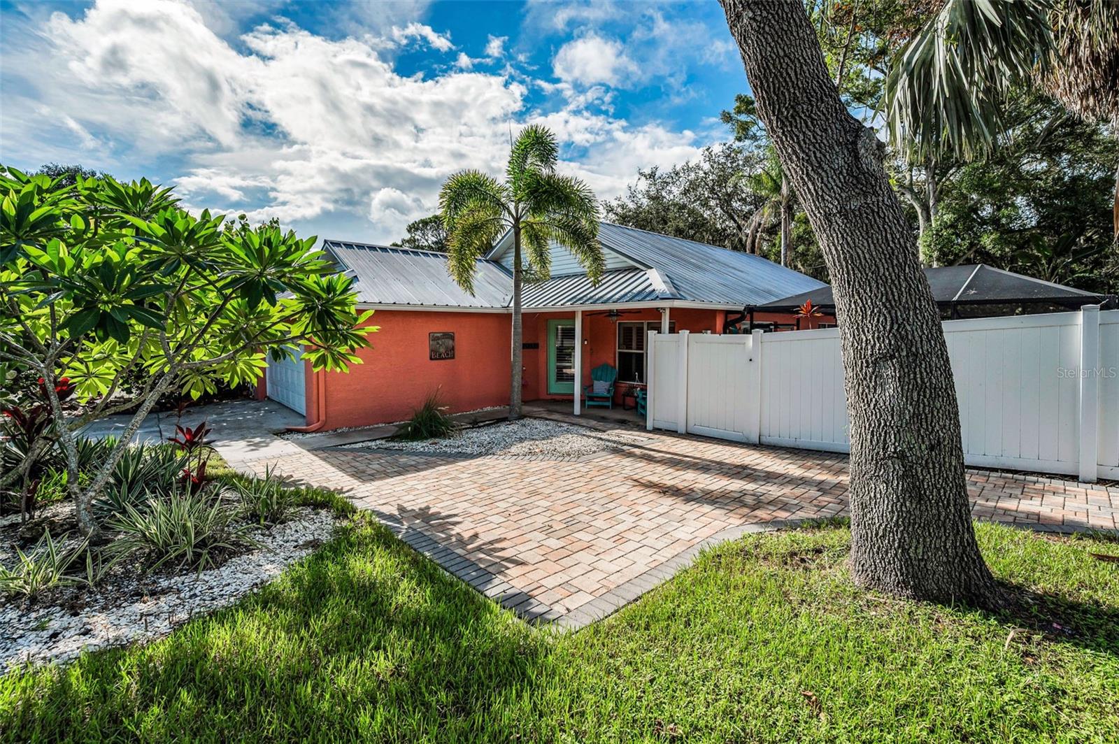 Looking for an Oasis in the Sought-After Ozona Beach Community that DID NOT FLOOD? Flood insurance currently $918. Nestled in the beloved beach community of Ozona (Land of Oz), this home has an 11-foot Base Flood Elevation above the Gulf of America. This stunning 3-bedroom, 2-bath single-family home offers the ultimate in Florida coastal living. Enjoy the charm of a golf-cart friendly community with easy access to local restaurants, boutique shopping, and the beach just minutes away.
Step inside and fall in love with the open-concept floor plan, towering ceilings, and natural light flowing through newer double-pane windows. The spacious kitchen features natural gas cooking, ideal for the home chef, and seamlessly connects to the living and dining areas—perfect for entertaining. Plantation shutters throughout the home add an elegant touch, while six ceiling fans keep things breezy year-round. The primary suite is generously sized with 2 large closets, and each additional bedroom offers comfort and privacy. Plantation shutters throughout the home add an elegant touch, while six ceiling fans keep things breezy year-round.
Outside, escape to your own private tropical paradise. The Pebble Tech saltwater pool (installed in 2019) is fully caged and features a waterfall, ambient lighting, and beautiful paver decking, all surrounded by lush, tropical landscaping and vinyl fencing for added privacy. Enjoy morning coffee or sunset views from the heated/cooled enclosed patio overlooking the pool. Additional features include: Metal roof (2017), HVAC system (2024), microwave 2025, dishwasher 2023, 2-car attached garage, hurricane shutters, washer & dryer included, Palm Harbor A -Rated Schools (Ozona Elementary, Palm Harbor Middle, Palm Harbor University High School). Don’t miss your chance to own this move-in ready retreat in one of the Gulf Coast’s most unique and inviting neighborhoods. Come experience the magic of the Land of Oz!
