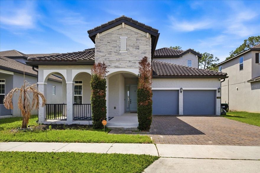 One or more photo(s) has been virtually staged. Step into a home that truly has it all. From the moment you arrive, the curb appeal stands out with its stone-accented elevation, paver driveway, and inviting entry. Inside, you’ll find a thoughtfully designed open floor plan with wood-look tile throughout the main living areas, crown molding throughout the entire home, and a layout that balances everyday comfort with effortless entertaining.

The kitchen is the heart of the home, featuring an oversized island, upgraded cabinetry, microwave and oven, under-cabinet lighting, and plenty of space for gathering. It opens seamlessly to the living and dining areas, all overlooking the backyard oasis.

The primary suite offers a peaceful retreat with views of the pool, while the spa-style bathroom includes dual vanities, a soaking tub, and a separate shower. A private in-law suite provides flexibility for guests or multi-generational living. Upstairs, a large bonus room wired for surround sound is ready for a home theater or game room.

Step outside and you’ll understand what makes this home special. The backyard is fully fenced and designed for entertaining with a custom pool, spa, water features, and multiple seating areas. The covered lanai includes automatic retractable screens, allowing you to enjoy the space year-round. In the evenings, take in Disney fireworks right from your pool or primary bedroom.

Additional upgrades include exterior holiday lighting with hundreds of color options, enhanced landscape and pool lighting, a water softener system, and professional storage racks in the garage.

This home offers the perfect combination of style, function, and outdoor living in one exceptional property.