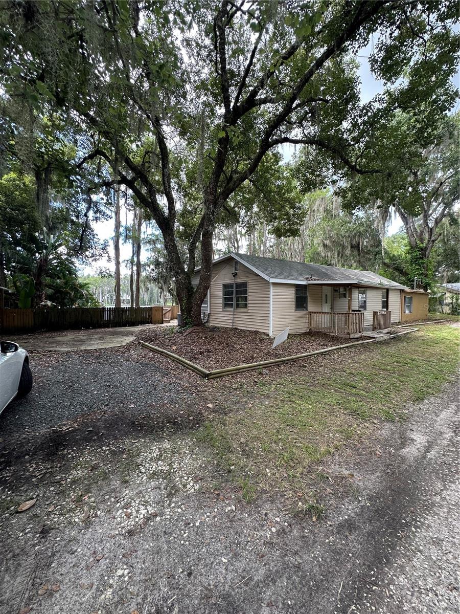 TWO LAKEFRONT HOUSES !!! Fishing, rustic lake living, peace old Florida style, gorgeous neighborhood .This home would make a lovely homestead, or a great AirBNB investment. There is a tiny house/guest house/mother-in-law suite (a separate, fenced building in the same property )with a mini kitchen, bathroom, one bedroom, loft and its own little dock on the lake. This home has its own dock with cabana, the main 3/2 was remodeled a few years ago BUT NEEDS REPAIRS/UPDATES TO REACH ITS FULL POTENTIAL . This home has a BIG KITCHEN that overlooks the family room, open floor plan , master bedroom with walk-in closet, a second bathroom with views of the lake and laundry room, it has luxury vinyl plank flooring and tile. Picture relaxing sunsets at the dock or just fishing to your heart's content. All room dims are approximate. YOU MUST SEE THIS PROPERTY TO APPRECIATE IT!