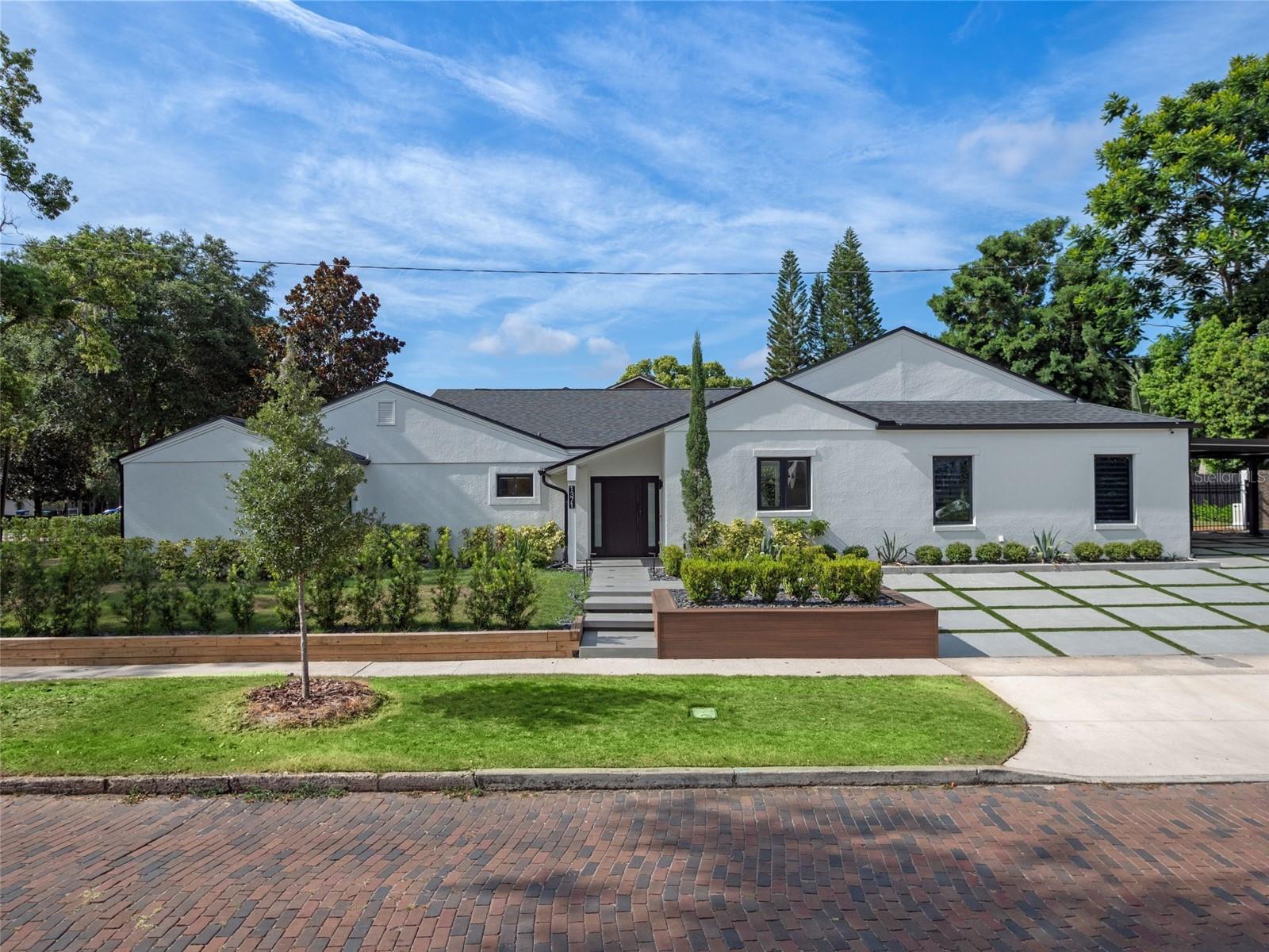 One or more photo(s) has been virtually staged. As you enter this renovated 4-bedroom, 2.5-bathroom home within the city limits of Winter Park, you're immediately welcomed by a bright, open living and dining area anchored by a stunning wet bar, complete with sink, cabinetry, ice maker, and floating shelves. All completed with light modern porcelain tile flooring.
To your right, the kitchen makes a bold statement with dramatic 4.5-inch thick countertops, waterfall-edge island, oversized farm sink, and high-end appliances including a Thermador induction stove and Whirlpool double oven, microwave, dishwasher, and fridge/freezer. Custom soft-close cabinetry blends seamlessly into the open layout, offering style and serious storage.
Just beyond the hurricane rated sliding glass doors, you'll find a covered lanai and spacious yard with a mix of grass and artificial turf, ideal for entertaining, relaxing, or adding a future pool.
The primary suite is tucked away on the left side of the home, offering peace and privacy. It features soft lighting, remote-controlled shades, and two walk-in closets with built-ins. The spa-like en-suite bathroom combines wood and stone textures, a floating dual-sink vanity, and a large walk-in rain shower, all designed with modern feel.
Two additional bedrooms and a full bathroom are located down the same hallway, separated from the main living space by modern barn doors, perfect for creating a private wing for family or guests. On the opposite side of the home, a fourth bedroom makes a perfect office or guest suite. A nearby half bath opens to the outside, making it an ideal future pool bath.
The laundry room is equipped with LG Signature washer and dryer, a drying closet, sink, and built-in storage. Adjacent to the laundry area is a stylish mudroom with custom built-ins to keep everything organized.
Both the attached 2-car garage and carport make parking effortless. The garage is climate-controlled with a split AC unit and finished with sleek epoxy flooring, perfect for a gym, workshop, or additional storage. The garage is also equipped with EV charging capabilities. Set on a generous 0.33-acre corner lot, this property offers extra outdoor space, privacy, and potential, whether for a future pool, garden, or entertaining area.
Additional upgrades include a whole-house Generac generator, a tankless water heater with softener and filtration system, hurricane-rated windows and sliding doors, new roof (2021), updated plumbing and electrical (2022), and two new AC systems (2022). Non-textured walls and ceilings, smart lighting, and clean, minimalist finishes round out the home’s modern aesthetic.
Every detail of this home has been carefully curated to deliver a lifestyle of comfort, style, and function, a true modern retreat in the heart of Winter Park. This home is located just a short drive away from Park Avenue and its many restaurants and other businesses. Conveniently located close to major highways for easy commuting, schedule your private tour today.