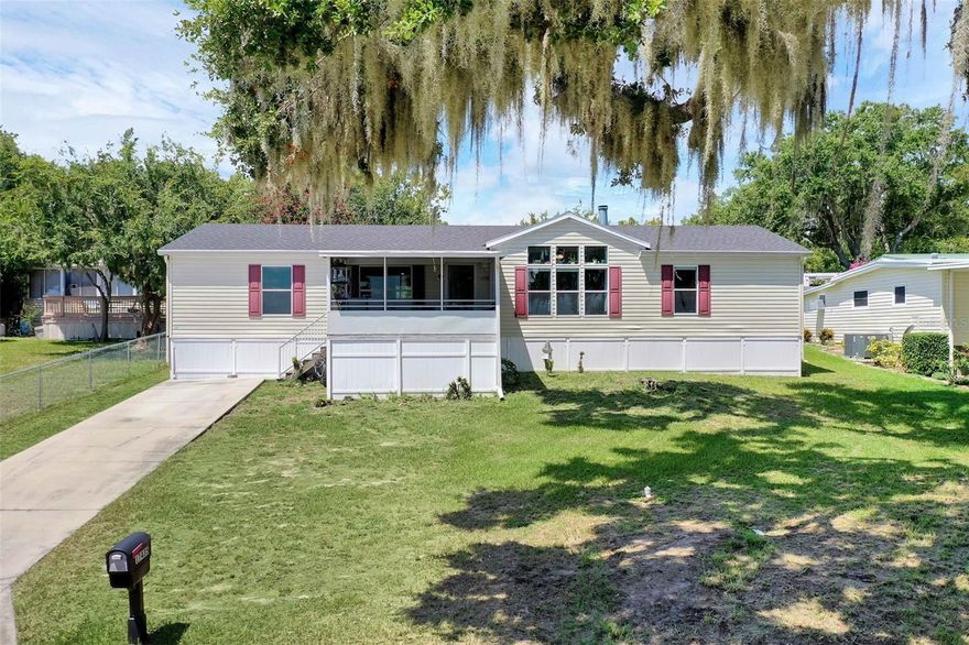 Discover the potential this oversized 3 bedroom, 2 bath manufactured home has with peaceful views of Lake Apopka and more! Offering a spacious layout and plenty of natural light the huge front windows that overlook Lake Apopka will give you views for days! New roof in 2022, Straps replaced in 2024, AC 2018 so the big ticket items are done. The primary suite provides a private retreat with a large ensuite bathroom and massive walk in closet, while the split floor plan ensures space and comfort for family or guests. The second bathroom and flooring are in need of renovation, making this the perfect opportunity to customize the home to your taste and style. Relax on the large screened in front porch while enjoying serene lake views. With a little TLC, this property could shine as your full-time residence, weekend getaway, or investment opportunity near the lake. This is a cash only purchase due to relocation. Located in a non HOA community with no restrictions. Bring your vision and unlock the full potential of this oversized home with Lake Apopka views, it’s ready for its next owner to make it shine.