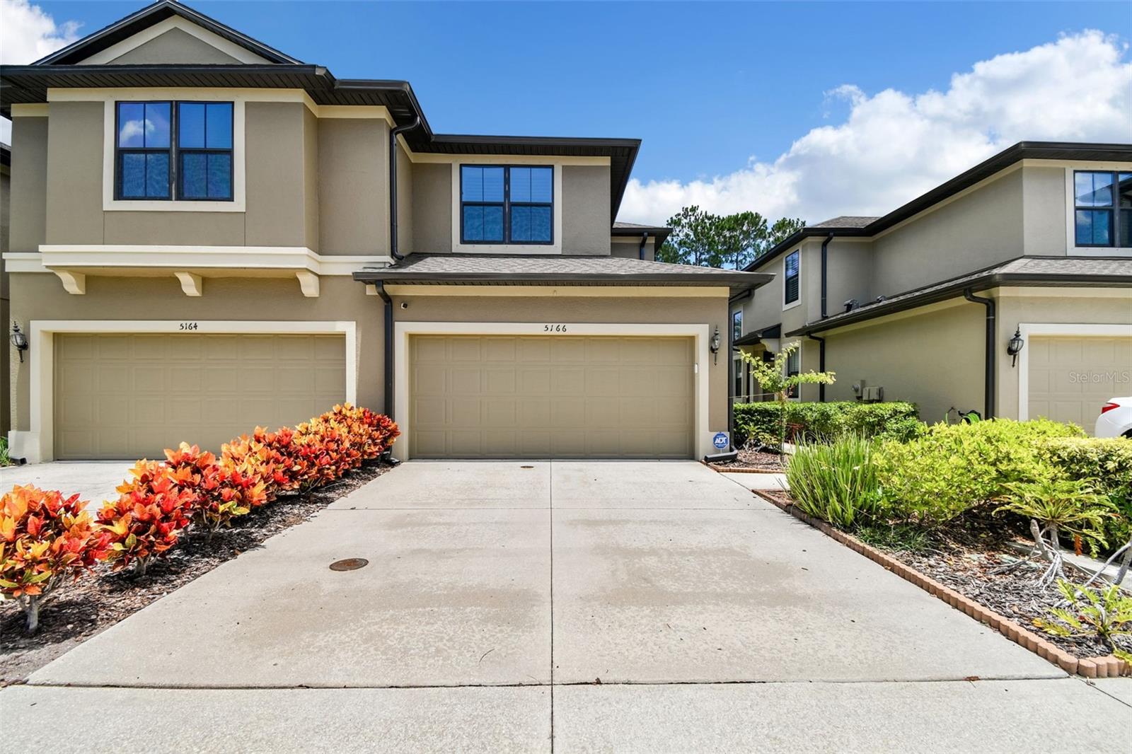 Welcome to 5166 Bay Isle Circle, an exquisite 3-bedroom, 2.5-bathroom townhome located in the sought-after community of Bay Isle Landings in Clearwater, Florida. This beautifully maintained residence offers a perfect blend of luxury, comfort, and convenience. Boasting over 2,000 square feet of living space, this home features an open floor plan with high ceilings and abundant natural light, creating a bright and inviting atmosphere. The modern kitchen is a chef’s dream, equipped with updated stainless steel appliances, granite countertops, a breakfast bar, and ample cabinetry for storage. The open layout seamlessly connects to the dining and living areas, perfect for entertaining. The expansive master suite offers a serene retreat with a walk-in closet and an en-suite bathroom featuring dual sinks, and a separate walk-in shower. Two generously sized bedrooms and a full bathroom are located on the second floor, providing ample space for family or guests. Enjoy the Florida lifestyle with a private screened lanai. This outdoor space is ideal for morning coffee, evening relaxation, or hosting gatherings. The townhome includes an attached two-car garage, a laundry room, hurricane shutters, a security system, and energy-efficient features for comfortable and cost-effective living. Bay Isle Landings offers residents access to a sparkling community pool and well-maintained common areas. The community is pet-friendly and provides a safe, gated environment. The townhome is conveniently situated near shopping, dining, entertainment, and top-rated schools with easy access to major highways and just a short drive to the beautiful Gulf beaches, Tampa International Airport, PIE International Airport, and downtown Clearwater. Don’t miss the opportunity to own this exceptional townhome in one of Clearwater’s premier communities. Schedule a private showing today and experience the best of Florida living!