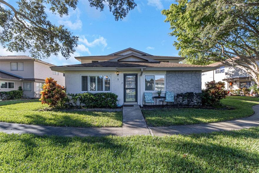 BEAUTIFUL 2-bedroom 1 bath condo in an ALL-AGE community.  Walking into this unit you will find an OPEN FLOOR PLAN with plenty of NATURAL LIGHT, NEWER modern LUXURY VINYL FLOORING throughout the main living areas of the condo, HURRICANE RATED WINDOWS and PLANTATION SHUTTERS.  Your kitchen has a LARGE PANTRY with PULL-OUT DRAWERS for easy access.   The master bedroom features a good amount of CLOSET SPACE WITH SHELVING.   The second bedroom doubles as an office and bedroom.  It has CUSTOM-BUILT CABINETS for office use,  MURPHY BED and a closet with shelving. NEWER AC installed in 2022.   Your COVERED OPEN GARAGE is perfect for keeping your car out of the sun.  Eastwood Pines is known to be a QUIET COMMUNITY with amenities that include a well-maintained POOL, regulation-size TENNIS COURTS and a private path leading to a FISHING PIER.   Conveniently located with quick access to US19, Courtney Campbell Causeway, I-275, St Pete-Clearwater Airport and golf courses.