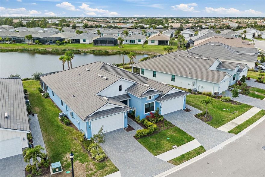 **DESIGNER FURNITURE (partial or all) and GOLF CART AVAILABLE FOR PURCHASE SEPARATELY OR INCLUDE INTO PROPOSAL.** Customized Toll Brothers Rosehall paired villa is loaded with top-of-the-line builder options PLUS additional custom upgrades after purchase including trim work, designer finishes and a huge expanded lanai with lake and fountain views. This beautifully maintained home features 2 bedrooms, 2 bathrooms, and a versatile flex room with a hidden bonus closet—currently styled as an office/TV room/guest space and easily used as a third bedroom. This home features tile flooring throughout, and the 2-car garage features an epoxy-coated garage floor. Notice the upgrades to this home and attention to detail: from the designer lighting & ceiling fans, custom doors, and elegant custom molding and trim work throughout, including eye-catching accent walls in the hallway and flex room. The executive gas kitchen, complete with built-in KitchenAid appliances, quartz counter tops, large island & custom pantry door. The guest bathroom is equally impressive, showcasing a UPGRADED gorgeous walk-in shower with upgraded tile and a luxury rain shower head in addition to the handheld. Open the back glass sliders to your huge expanded lanai that wraps around the back of the villa, featuring a picture-frame screen that creates unobstructed, postcard-worthy views of the serene lake and fountain—a true showstopper and the ideal place to relax morning or night. Schedule your private showing today.