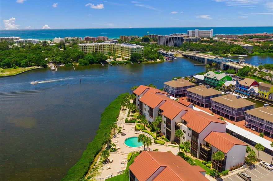 Fantastic opportunity to own a beautifully updated 1BR/1BA first-floor unit in highly desirable Castel Del Mare! This light and bright residence features a tiled entry and kitchen, with attractive laminate flooring throughout the remaining living areas. The spacious kitchen is equipped with white cabinetry, granite countertops, and stainless steel appliances—perfect for both everyday living and entertaining.  The generously sized primary suite offers a private, updated en-suite bath complete with granite counters and a walk-in shower.  What truly sets this unit apart is the in-unit washer and dryer—a rare convenience—along with an expansive double, oversized lanai just steps from the pool, creating the perfect space to relax and enjoy the Florida lifestyle.   Castel Del Mare is a sought-after waterfront community ideally located just steps from the South Bridge to Siesta Key—offering the best of both worlds with easy access to the beach while enjoying the convenience of mainland living.