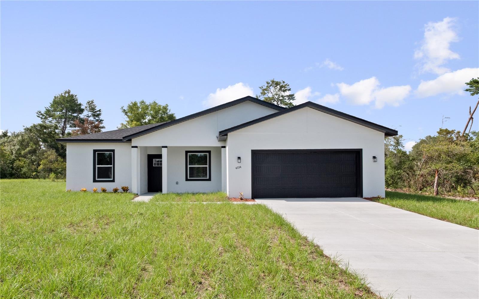 Beautiful New Rental in Ocala!
This modern 4-bedroom, 3-bath home with a versatile Den/Office offers style and comfort in every detail. The open concept floor plan showcases 9-ft ceilings, recessed lighting, and durable laminate flooring throughout the main living spaces. A chef's kitchen awaits with a striking waterfall island, pendant lighting, soft-close cabinetry, Whirlpool stainless steel appliances, and a dedicated coffee bar. The primary suite provides a spa-inspired retreat with a walk-in shower, soaking tub, and a spacious walk-in closet. Additional features include a convenient linen closet, inviting front porch, and a covered back porch ideal for outdoor gatherings. Nestled in the heart of Ocala, the Horse Capital of the World, this home is move-in ready so schedule your tour TODAY!