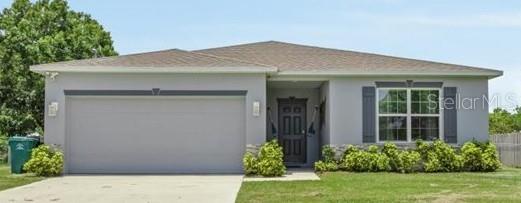 Welcome home to this 4 bedroom, 2 bath home with 2 car garage. The home is fully furnished making it a great investment opportunity for those looking to quickly get into Vacation Rentals. Great open floor plan with split bedrooms. The fully equipped kitchen and breakfast bar is the focal point, with granite countertops, stainless steel appliances, with plenty of cabinets and prep space, all overlooking the great room. Sliders lead to the large yard. Floor tile throughout, spacious primary suite with double vanity sinks in the adjoining bathroom and interior laundry room are other great features that make this home ready for your forever home! Located near Savannas Preserve State Park and easy access to Jensen Beach.