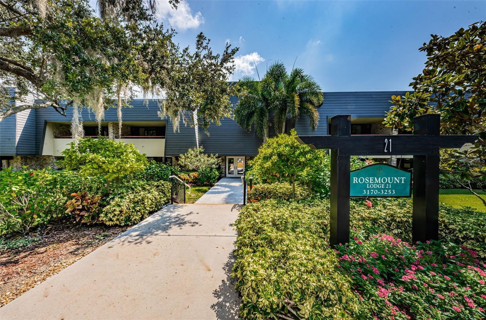 NOT in a FLOOD ZONE!! RENTED UNFURNISHED. BREATHTAKING VIEWS of the PGA Copperhead course are visible throughout this spacious beautiful condo. Take in STUNNING views of the Copperhead first hole on the hundred-yard line from the extended wrap-around patio that boasts sliders with lovely plantation shutters. A MUST SEE IN PERSON! This END UNIT, 2 bedroom, 2 bathroom, + den condo features newer attractive LUXURY VINYL FLOORING throughout the living area, kitchen, den, and second bedroom. The kitchen has newer cabinets and stylish touches such as a decorative metal ceiling with a cute chandelier. The dining area has a large dry bar area with extra cabinet space. The generously sized owner's suite features A NEW 2025 AC UNIT, dual sinks with separate vanities and a walk-in shower. Plenty of closet and storage space is abundant in this condo. The den area can be used for extra living space. The Rosemount building has three entrances, one conveniently located to this condo door entrance. Steps away is a large laundry room with an ice machine. Different levels of membership are available to enjoy the amenities, including the pools. Text or call agent, serious inquiries only. No EMAILS.