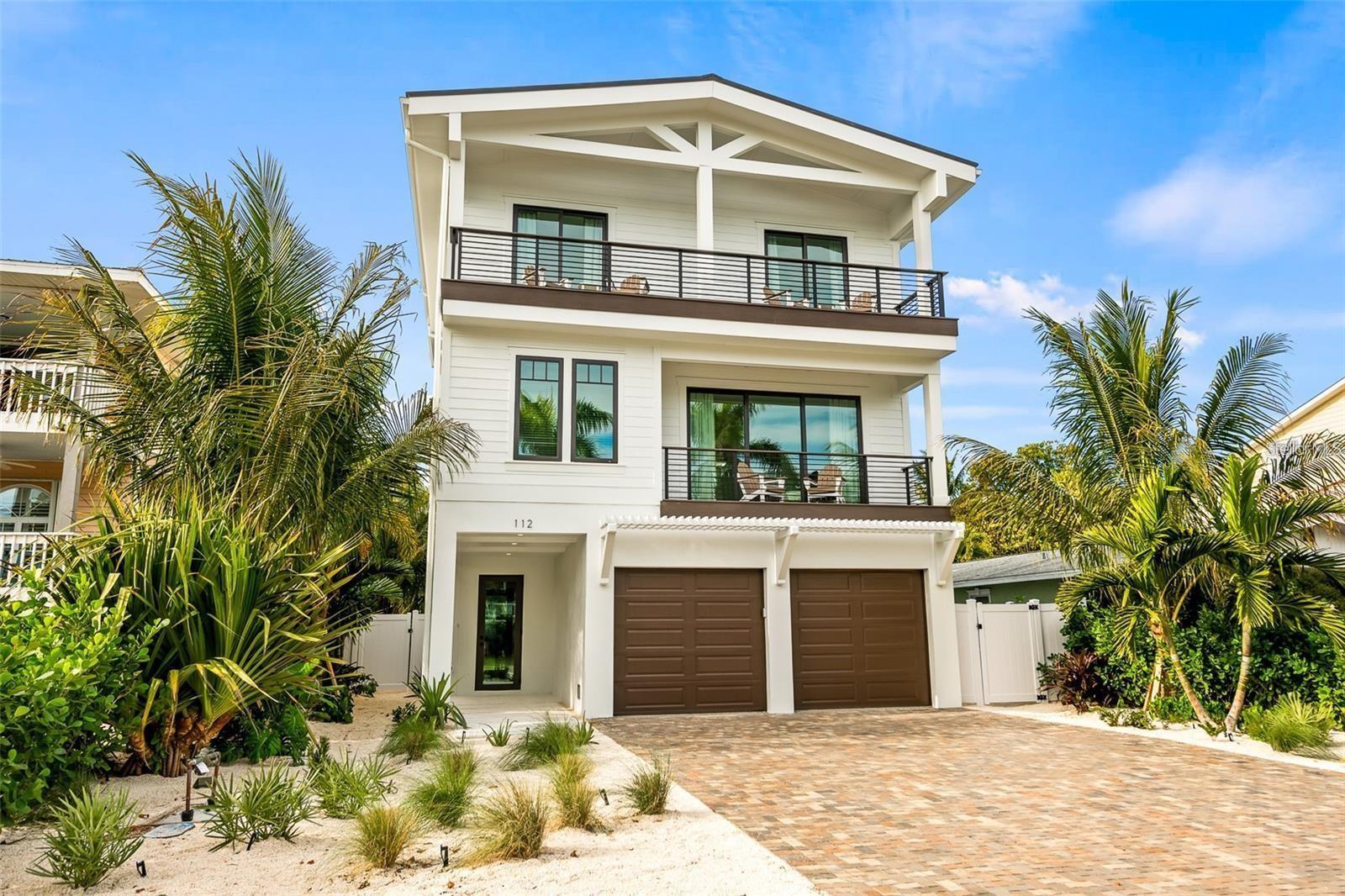 STUNNING NEW CONSTRUCTION HOME WEST OF GULF DRIVE! WELCOME TO THIS AMAZING FULLY FURNISHED 5 BEDROOM, 4.5 BATHROOM HOME LOCATED ON ONE OF THE PREMIER STREETS OF ANNA MARIA ISLAND!! With only 5 houses to the beach, this new construction gem is an absolute treasure. From the moment you set foot on the property, you'll be captivated by the thoughtfully designed custom features, including a paver driveway and lush tropical landscaping. Step inside and experience the open and spacious main living area, featuring a great room floor plan that seamlessly connects to an incredible deck through sliding glass doors. This expansive outdoor space offers ample room for outdoor dining and a comfortable sitting area, allowing you to fully embrace the island lifestyle. The kitchen is a chef's dream, boasting high-end appliances, a designer backsplash, a large center island with a breakfast bar, and stylish pendant lights. Retreat to the luxurious master suite at the end of a day filled with beach adventures. It features a sitting area and an incredible bathroom with dual sinks, a garden tub, and a walk-in shower. An additional guest bedroom on the same floor offers the convenience of an ensuite bathroom. Upstairs you will find three bedrooms and two bathrooms as well as a wetbar/coffee bar area. Step outside to the expansive area featuring an outdoor kitchen, dining area and turf area perfect for entertaining and hanging out. The roof top balcony offers breathtaking views of the Gulf, creating a serene setting for relaxation. The amount of outdoor living space in this home is truly one of a kind.The backyard of this home is your own private tropical oasis, complete with a heated pool and spa. Here, you can indulge in luxury living on Anna Maria Island and enjoy the tranquil surroundings. The finishes and attention to detail throughout the home are unmatched, ensuring an exceptional living experience. Whether you're in search of your forever home or a lucrative investment property, this is the one for you. With its prime location just a short distance to Pine Ave, where you'll find a variety of restaurants and shops, this home offers the perfect blend of convenience and tranquility. Don't miss out on the opportunity to own this incredible property. HOME IS CURRENTLY A SUCCESSFUL RENTAL PROPERTY. Schedule a showing today and secure your chance to own a piece of Anna Maria Island's luxury living.