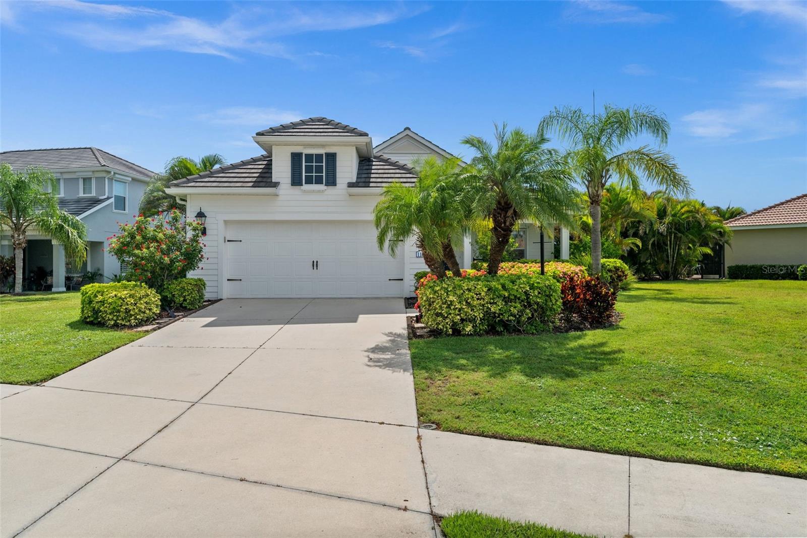 Your dream coastal pool home awaits in the amenity-rich community of Grand Palm. This beautifully upgraded Whitesand floor plan offers 3 bedrooms, 2.5 baths, a den and an open-concept layout designed for comfortable living and effortless entertaining. Situated on an oversized lakefront lot, the home welcomes you with pristine landscaping and peaceful water views. Inside, the bright great room flows into a spacious kitchen with a large island, walk-in pantry and gas appliances —a rare find in Florida. There’s also a gas stub on the lanai for outdoor grilling.
The owner’s suite features dual vanities and a walk-in shower, offering a private and relaxing retreat. Additional upgrades include Storm Smart hurricane screens on the entire home, crown molding, plantation shutters and a full-home storm surge protector for peace of mind during storm season. The separate laundry room includes a washer, dryer, utility sink and extra shelving.
Step outside to the extended covered and screened lanai, where a pristine heated saltwater pool ranging from 3 to 6 feet deep overlooks sweeping lake views. The oversized lot provides extra privacy, making it the perfect setting for outdoor entertaining or simply enjoying Florida sunsets.
Grand Palm is known for its vibrant and active lifestyle, offering over 28 miles of trails, clubhouse, fitness center, resort-style pools, tennis, pickleball, volleyball, basketball, fishing, dog parks and so much more. This is coastal Florida living at its finest!