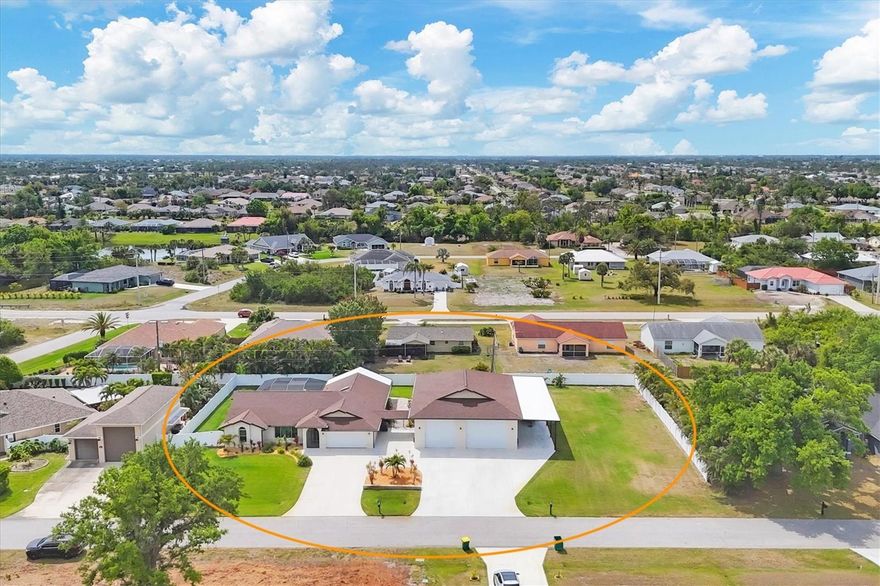 Discover the perfect blend of luxury, space, and functionality in this beautifully updated 3-bedroom, 2-bathroom POOL HOME on an OVERSIZED 2.5-LOT property. Designed for those who want it all, this home features an impressive 2,200 SQ FT GARAGE —large enough to accommodate up to 10 vehicles, boats, or RVs! Whether you’re a car enthusiast, need a workshop, or crave extra storage, this is a rare find that checks every box.

From the moment you arrive, the expansive circular driveway and inviting curb appeal set the tone for what’s inside. Step through the front door to a bright, open floor plan with wood-look ceramic tile flooring, modern finishes, and natural light throughout. The show-stopping kitchen is the heart of the home, showcasing granite countertops, a spacious center island with bar seating, custom cabinetry, stainless steel appliances, a wine fridge, and a beautiful backsplash that ties it all together.

Two spacious living areas—each with French doors leading to the lanai and pool—create seamless indoor-outdoor living. The master suite offers its own French doors, dual closets, and a spa-inspired bathroom with dual sinks, granite counters, and a stunning walk-in shower.

Step outside to your private tropical retreat featuring a sparkling pavered pool and panoramic screen enclosure (2019), a dedicated grilling and fire pit area, and a lean-to for extra storage. Through the breezeway, the massive 2,200 sq. ft. detached garage/shop awaits, complete with epoxy flooring, RV-height doors, a mini-split AC, and endless possibilities for use.

With no HOA, an X Flood Zone location (where flood insurance is typically not required), and close proximity to beaches, shopping, dining, and recreation, this property offers peace of mind, freedom, and lifestyle all in one.

Homes like this don’t come around often — schedule your private showing today and experience everything this exceptional property has to offer!