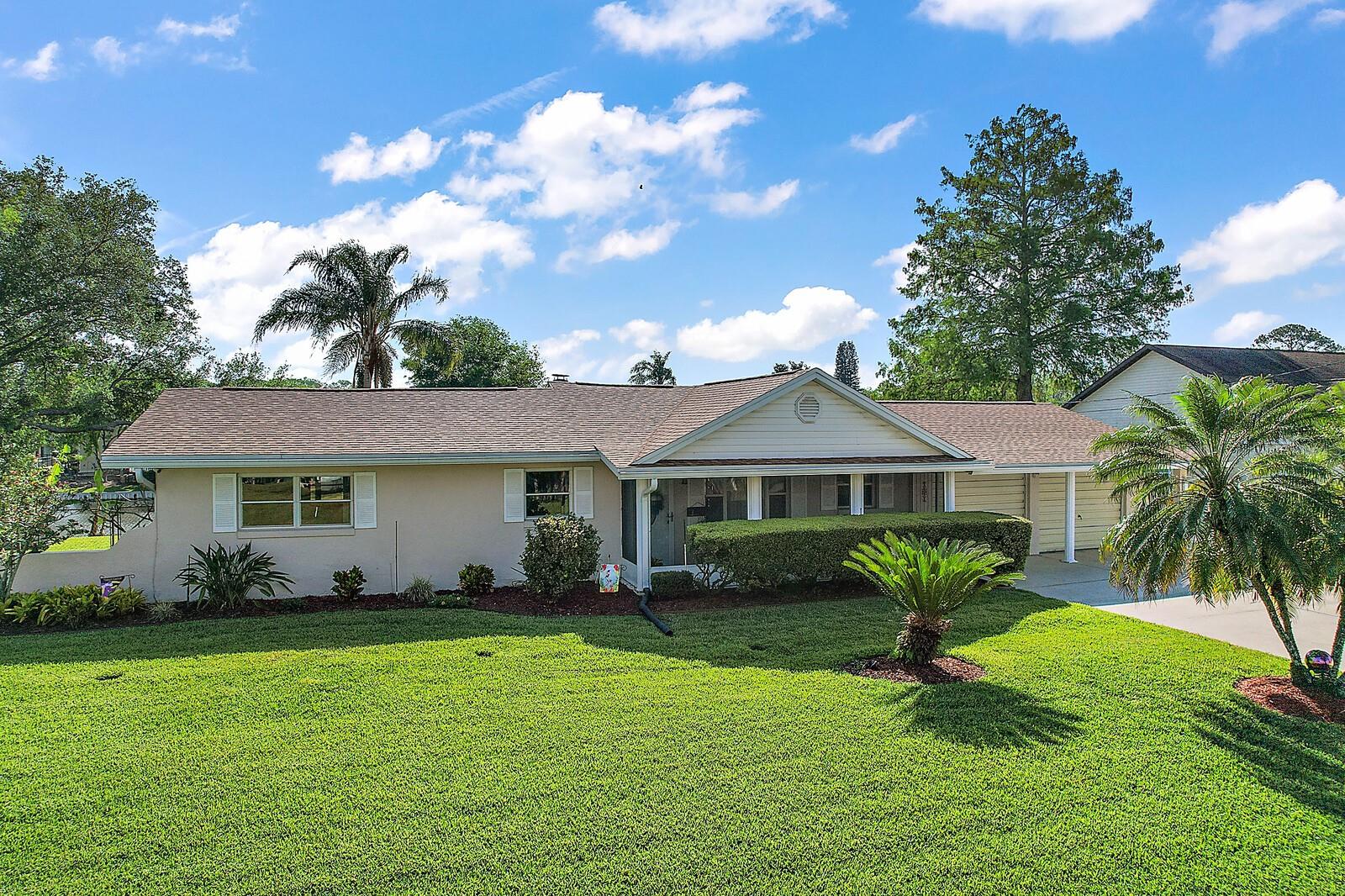 BOATERS DREAM WITH CANAL FRONTAGE AND ACCESS TO THE HARRIS CHAIN OF LAKE! This 3 bedroom, 2 bath home sits on a large double lot. The features plush mature landscaping with vaious fruits trees, a night blooming catus and even an herb garden. The home is fenced and has a newly rebuilt and repaired Sea Wall and composite dock in 2020 and also comes with a covered electronic boat lift. A new roof was put on in 2021, a new water heater in 2019 and even has a 90'ft well with a water filtration system. With this home situated on a deep and wide canal makes it easy to navigate your boat just a short distance into Harris Chain of Lakes. The interior of the home features a spacious living and dining area along with a wood burning stove. The kitchen appliances are newer and the bathrooms have been partially renovated. There is a large covered addition located behind the garage that could easily add square footage for a hobby room, a game room area or MAN CAVE! This also has a front screened porch and nice Florida room on the back of the home. The community offers a private boat ramp to launch your with a club house and beach area fronting Little Lake Harris. And the HOA is competely optional to join with this home! So, come see this wonderful home today and see what true satification lake and boating lifestyle living has to offer!